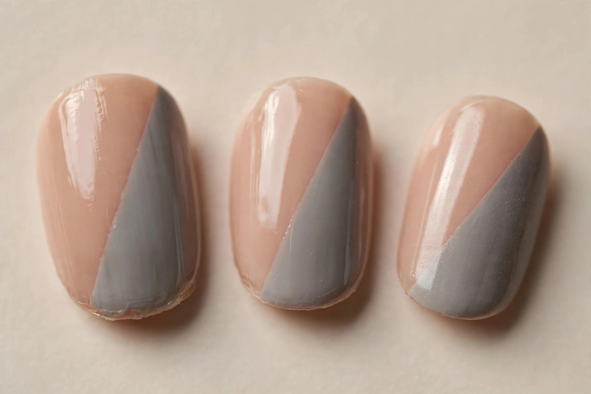 short oval nails, diagonal nude and mid-grey colour block, glossy