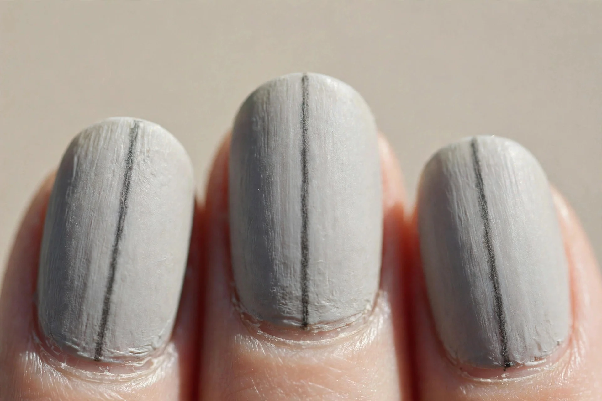 pale grey nails, one thin vertical charcoal stripe down each centre