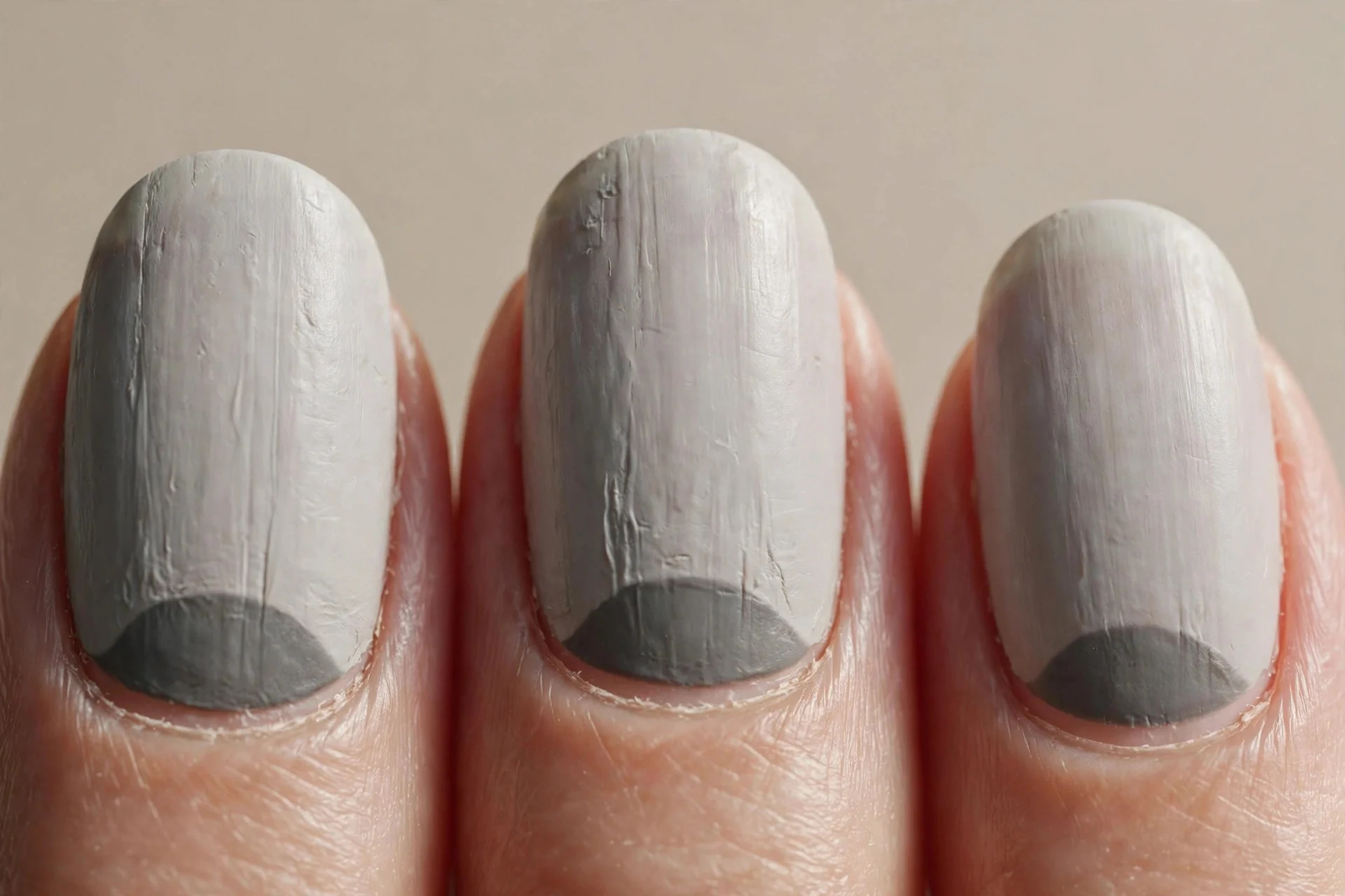 pale grey nails, dark grey half-moon crescent at each cuticle