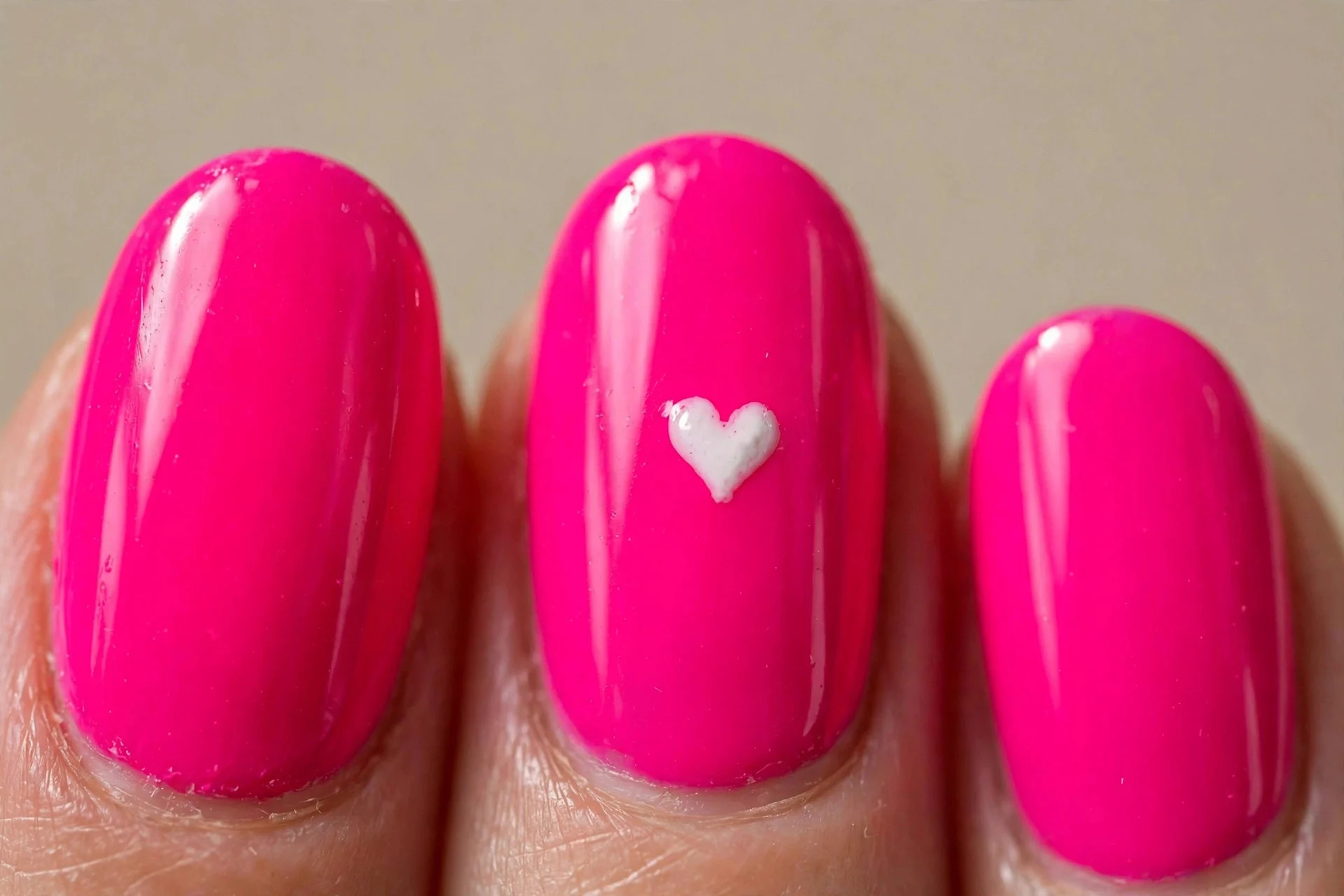 oval nails, neon-fuchsia pink, white heart accent, glossy