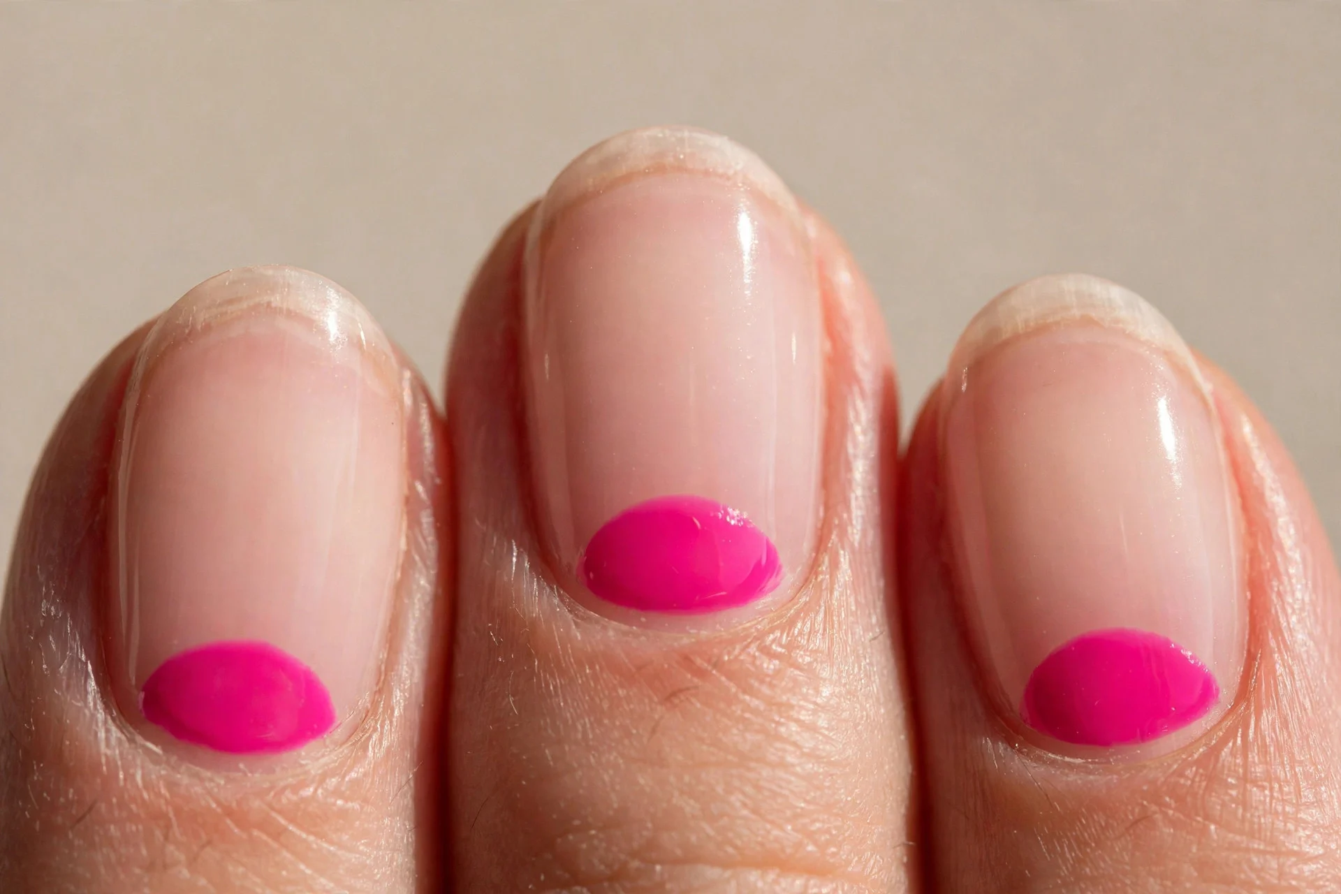 oval nails, nude base, hot pink half-moon, glossy