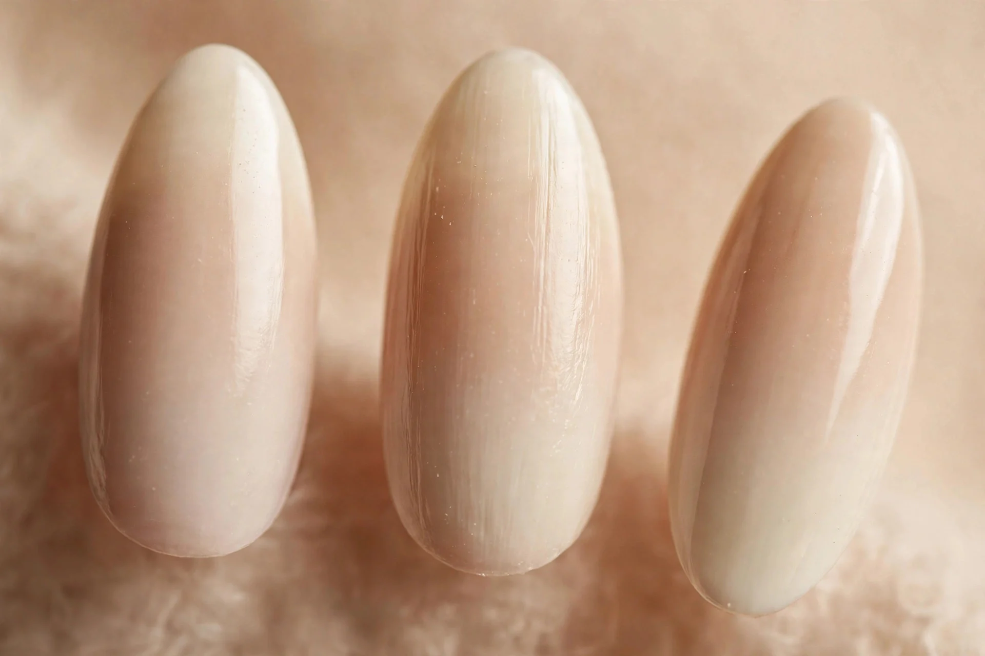 Almond nails with oat-milk to cream ombré, warm beige background