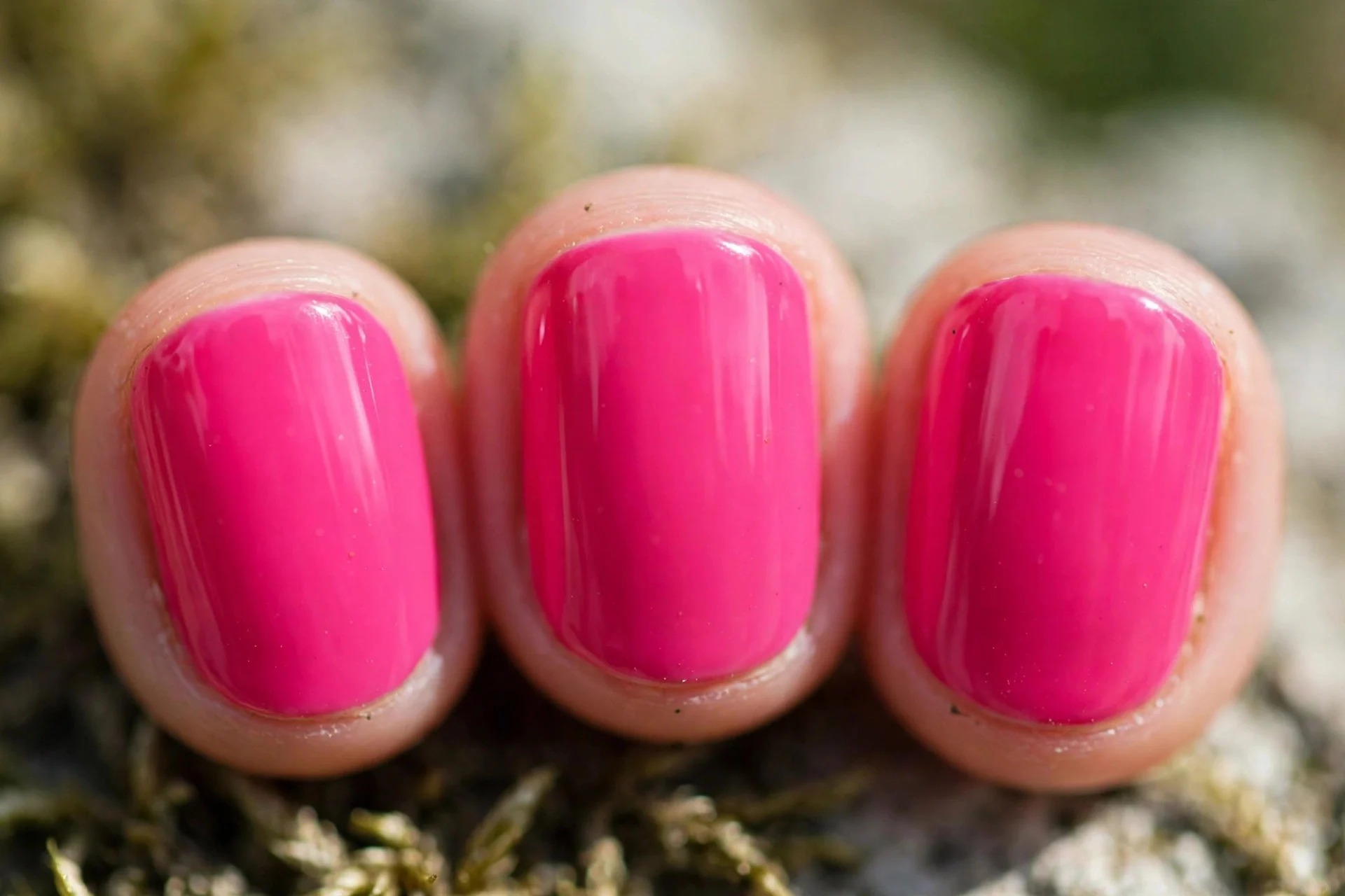 Single-coat hot pink polish, three-stroke application, short nails