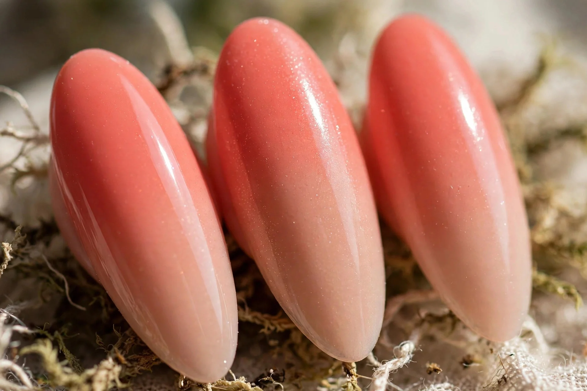 Coral to nude gel ombr&eacute;, long almond nails