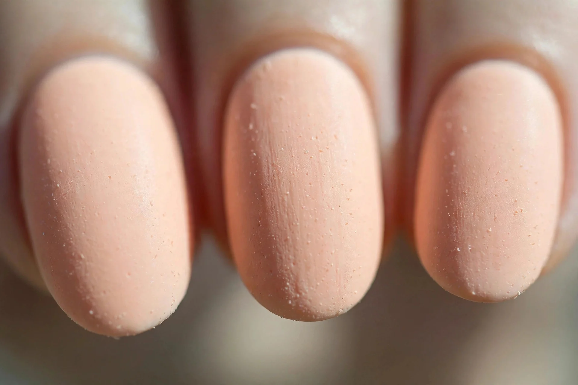 Opaque peach cream polish, short oval nails