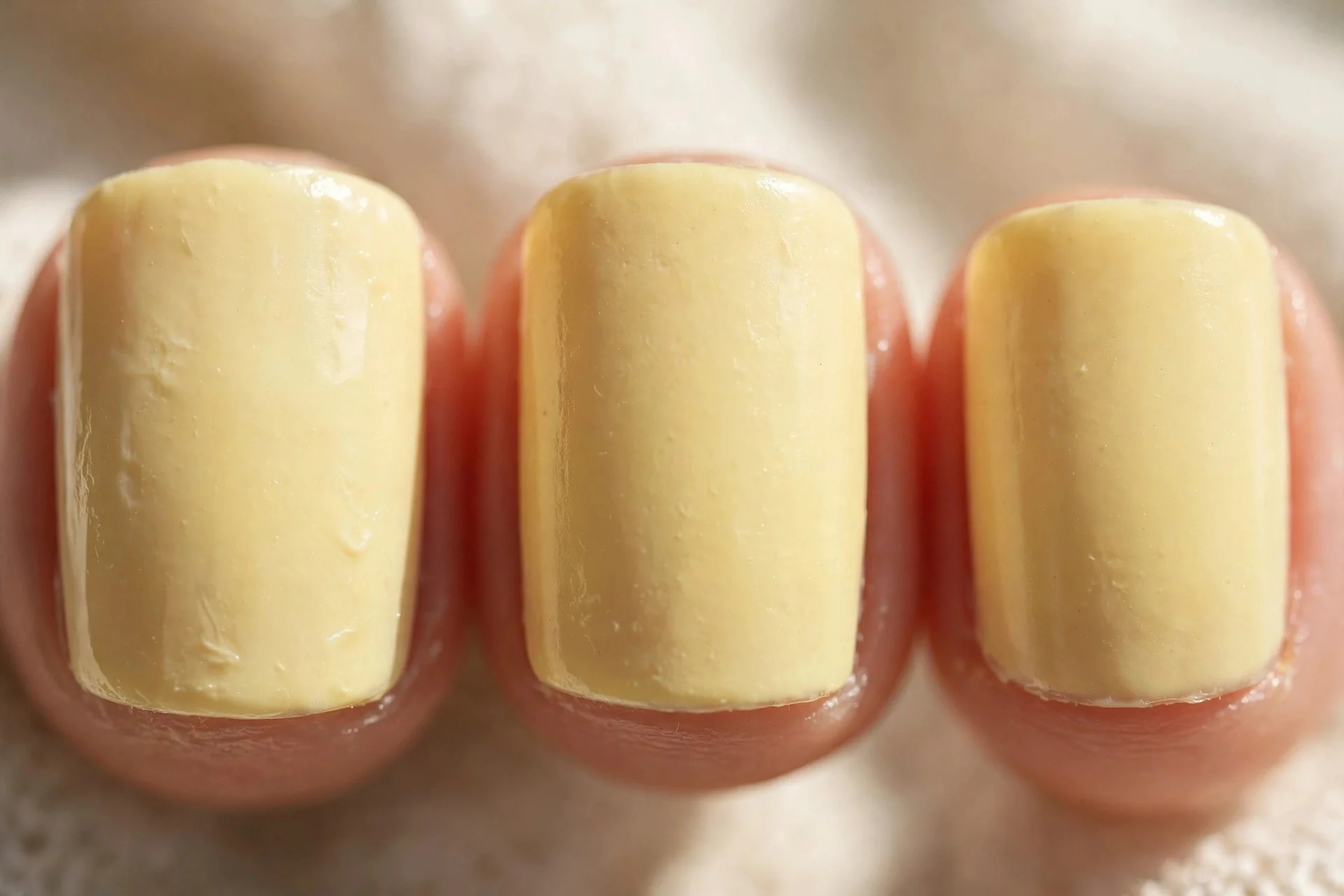 Pale lemon cream polish, short square nails