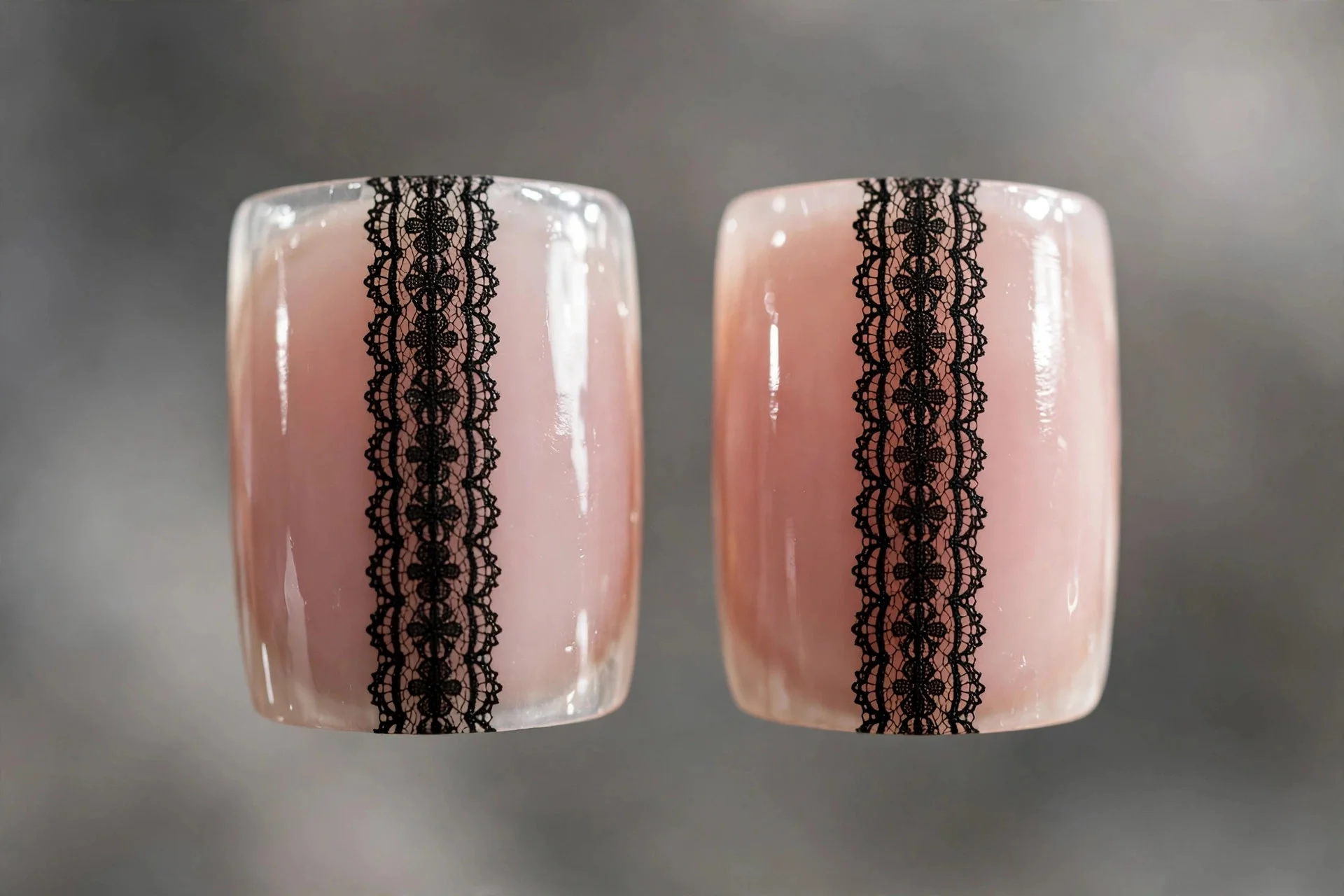 Square nails with centered black lace panel on bare natural nail, negative space edges, glossy, gray background