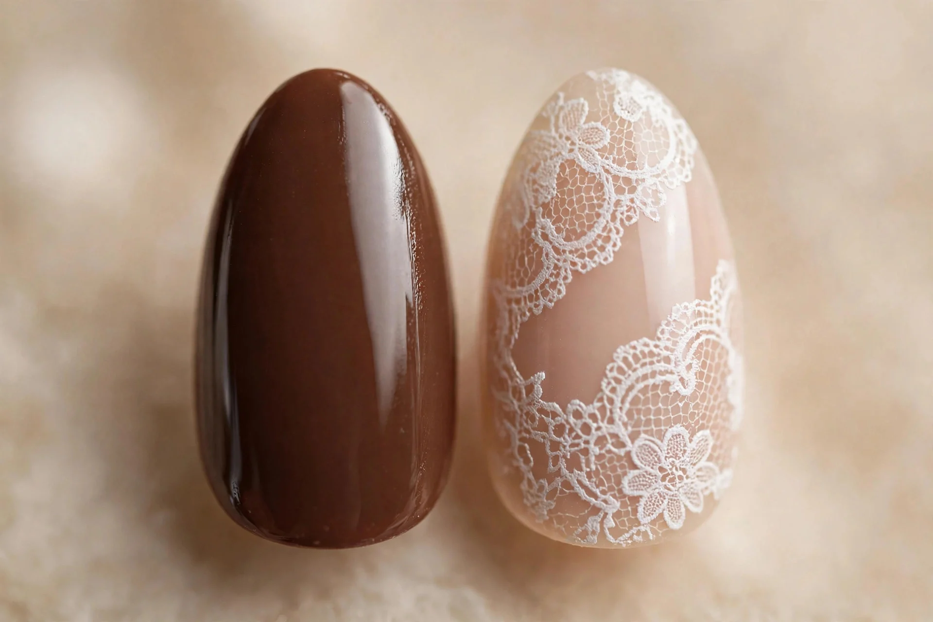 Almond nails, one solid chocolate brown and one with white lace stamping over nude, glossy, beige background