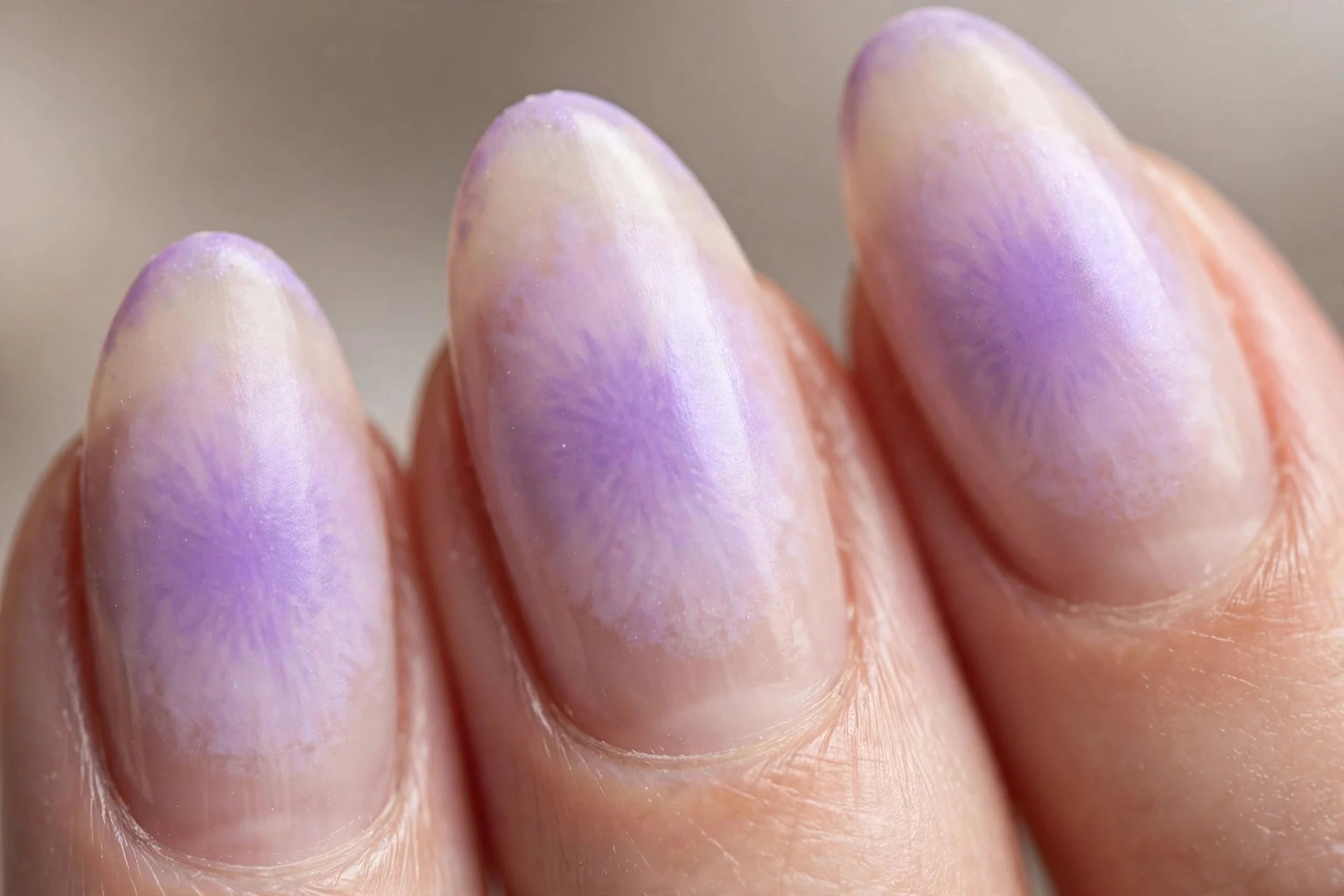 Lavender aura nails with colour blooming at centre fading to sheer nude base, almond nails