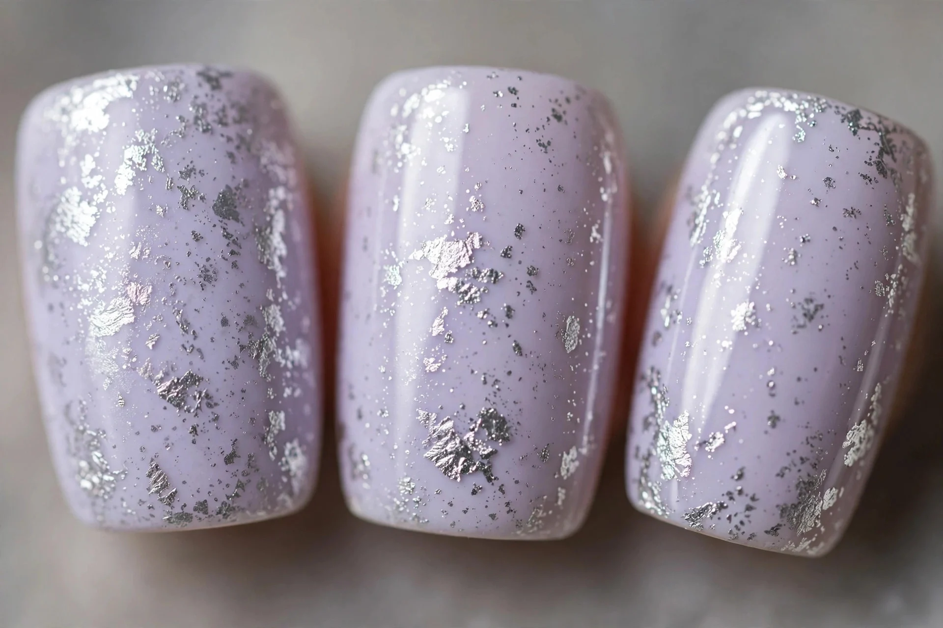 Pale lavender nails with silver foil flakes, medium square nails, glossy