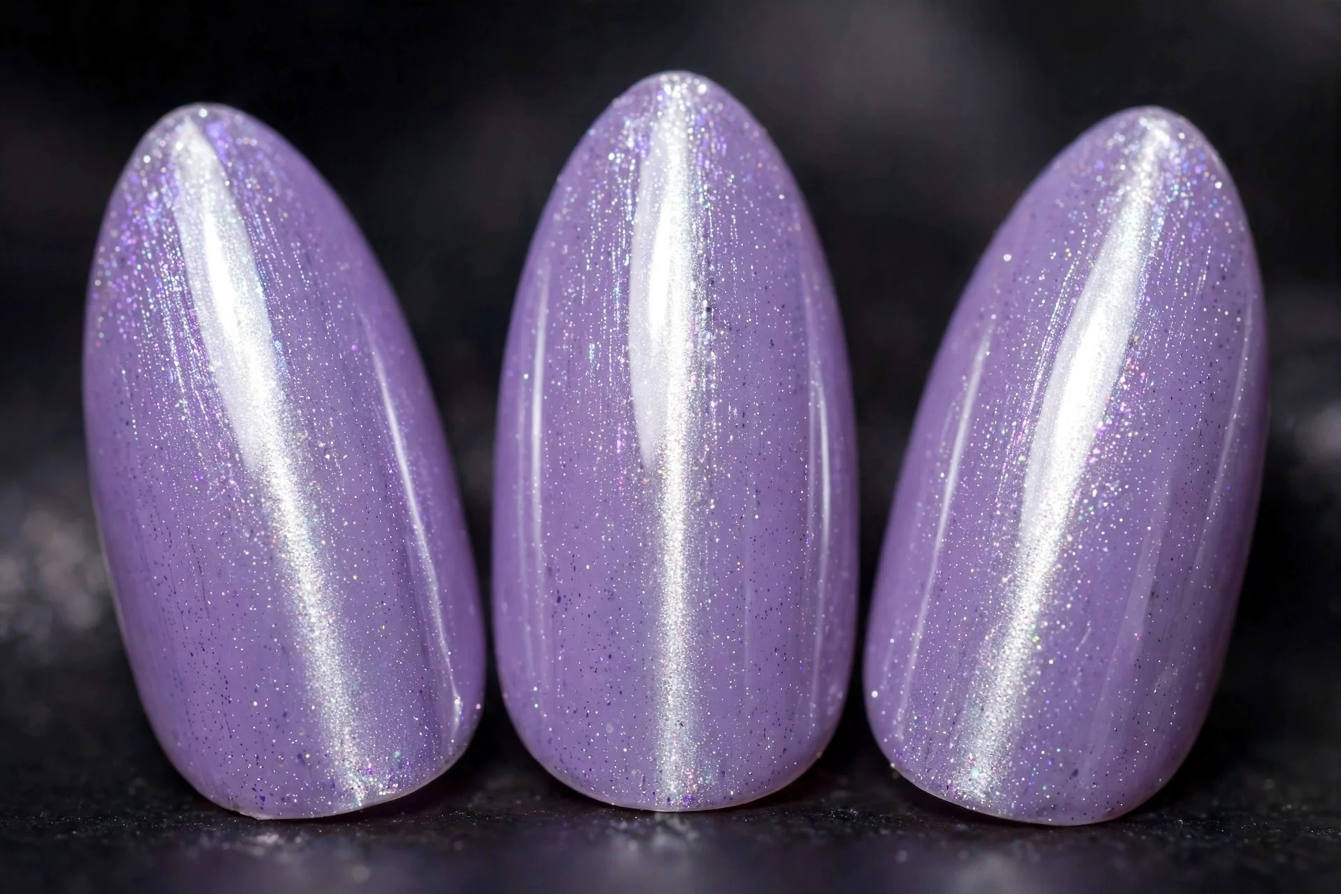 Lavender magnetic cat-eye nails with glowing silver centre line, almond nails