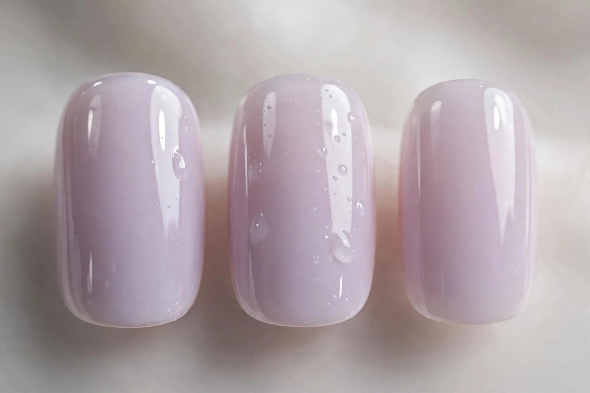 Sheer milky lavender nails, short squoval nails, juicy gloss