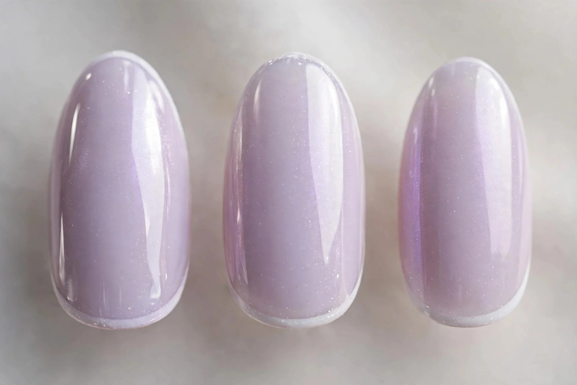 Glazed French nails with lavender-tinted base and white micro tips, almond