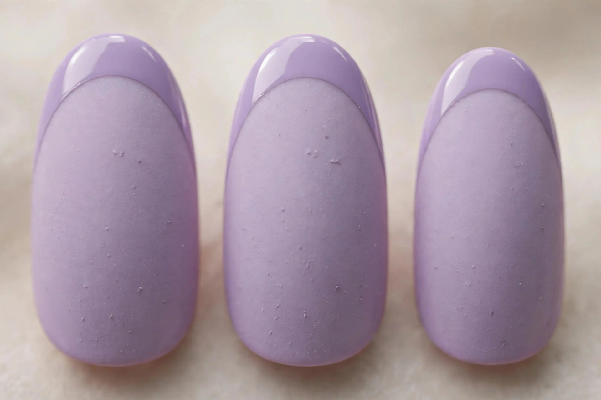 Matte lavender nails with glossy lavender French tips, medium almond