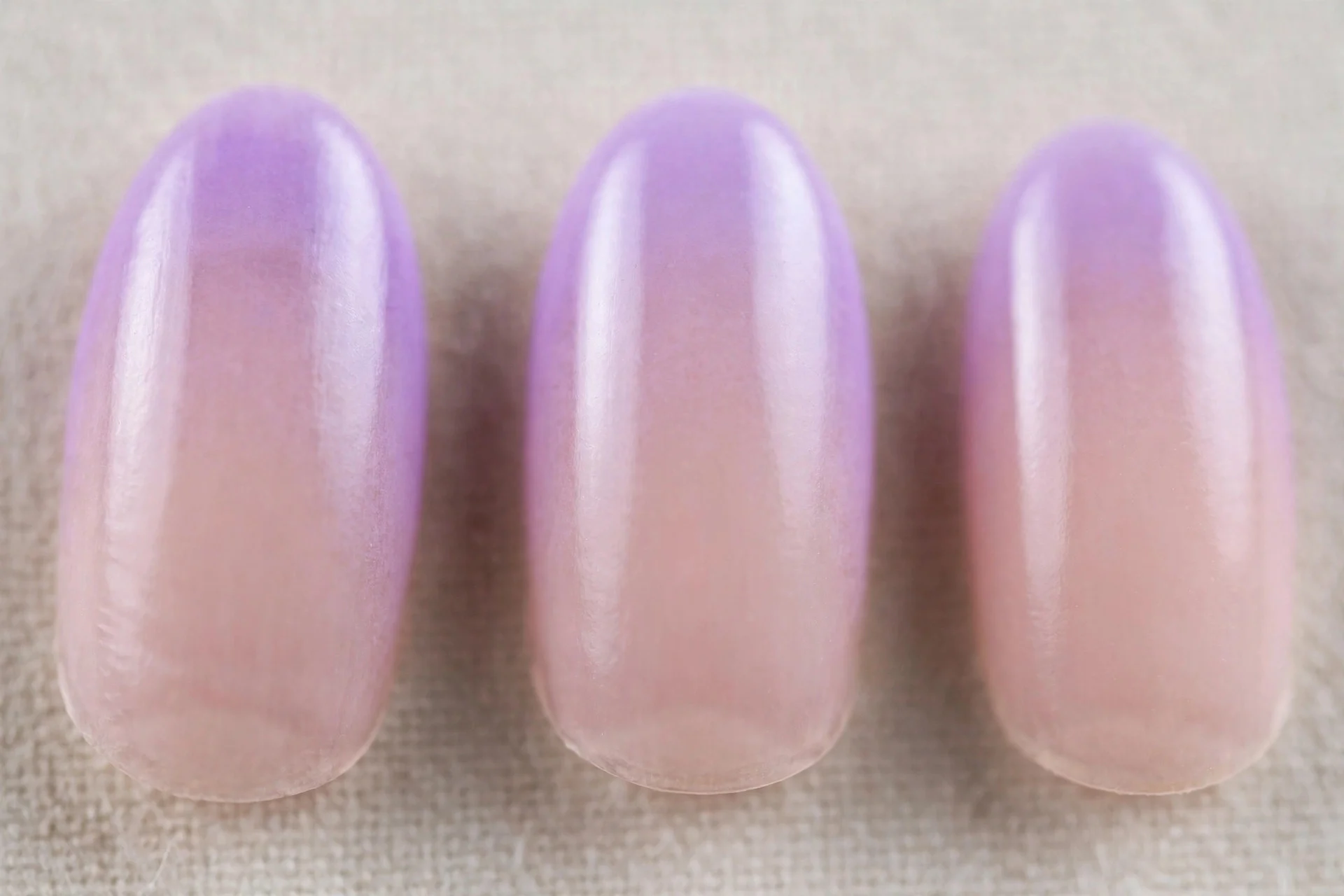 Lilac aura nails fading to sheer nude base, oval nails