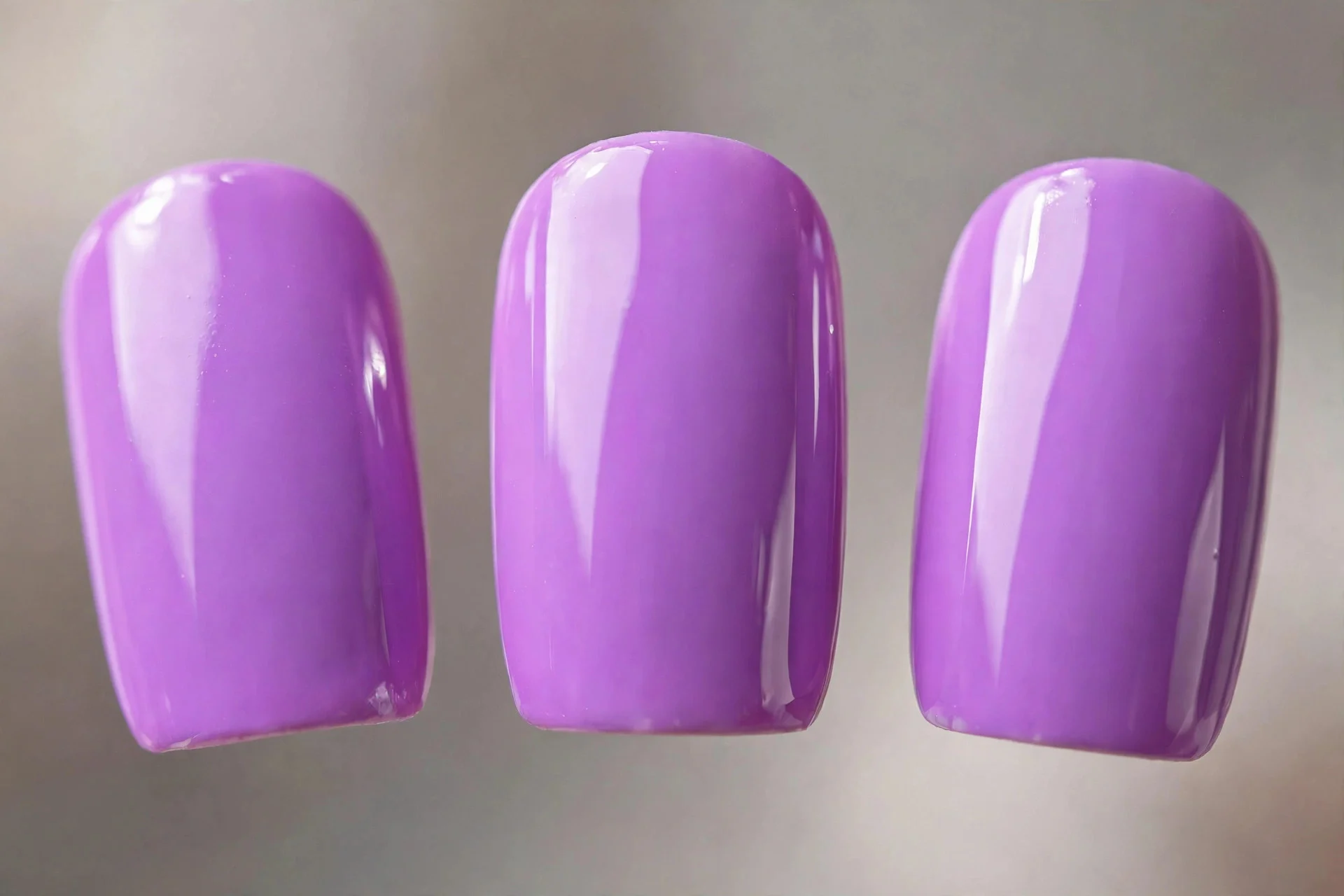 Vivid bright lilac polish, short almond nails, glossy