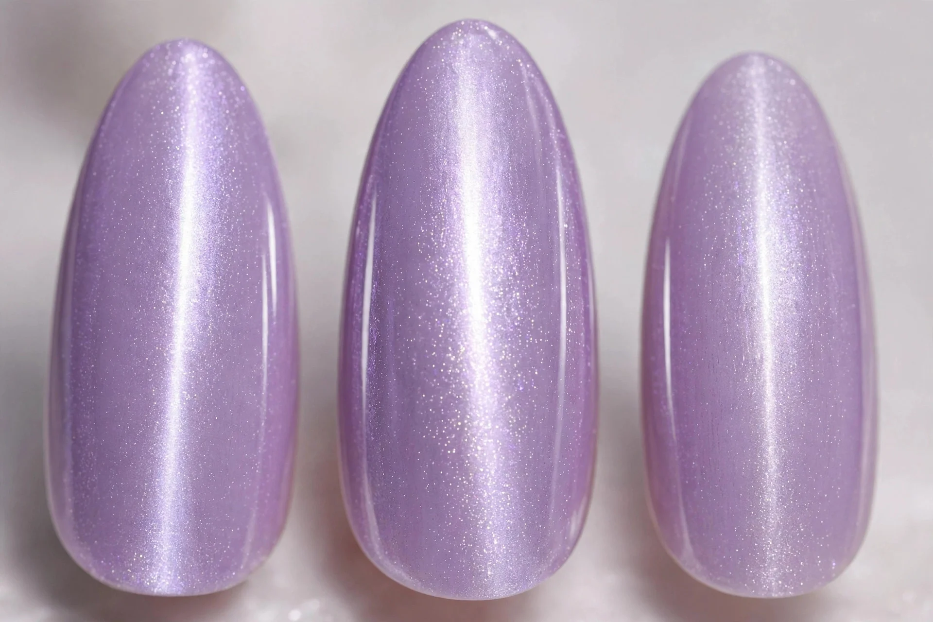 Lilac magnetic cat-eye nails with glowing centre line, long almond