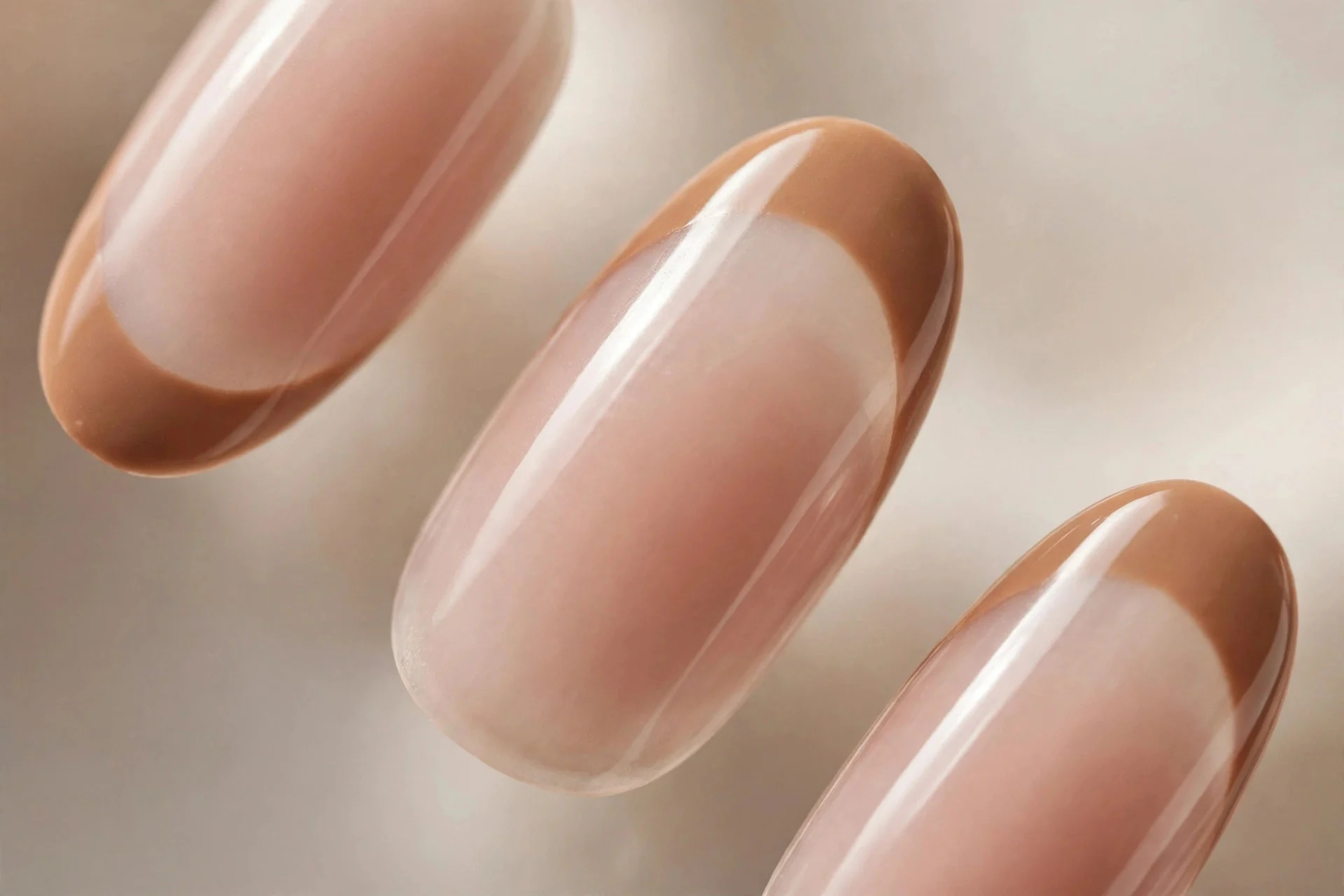 Camel French tips on sheer nude, almond