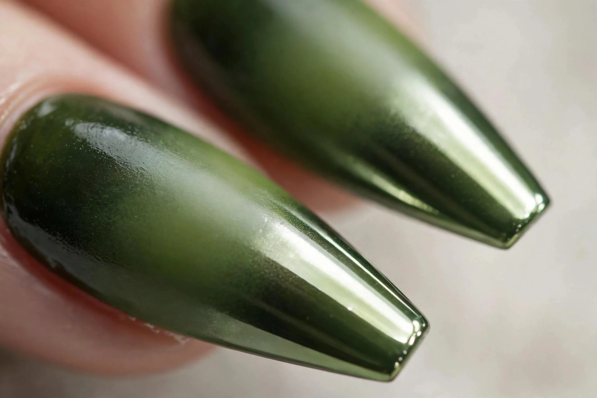 Coffin nails fading from deep matcha base to glazed chrome matcha tips, glossy, neutral background