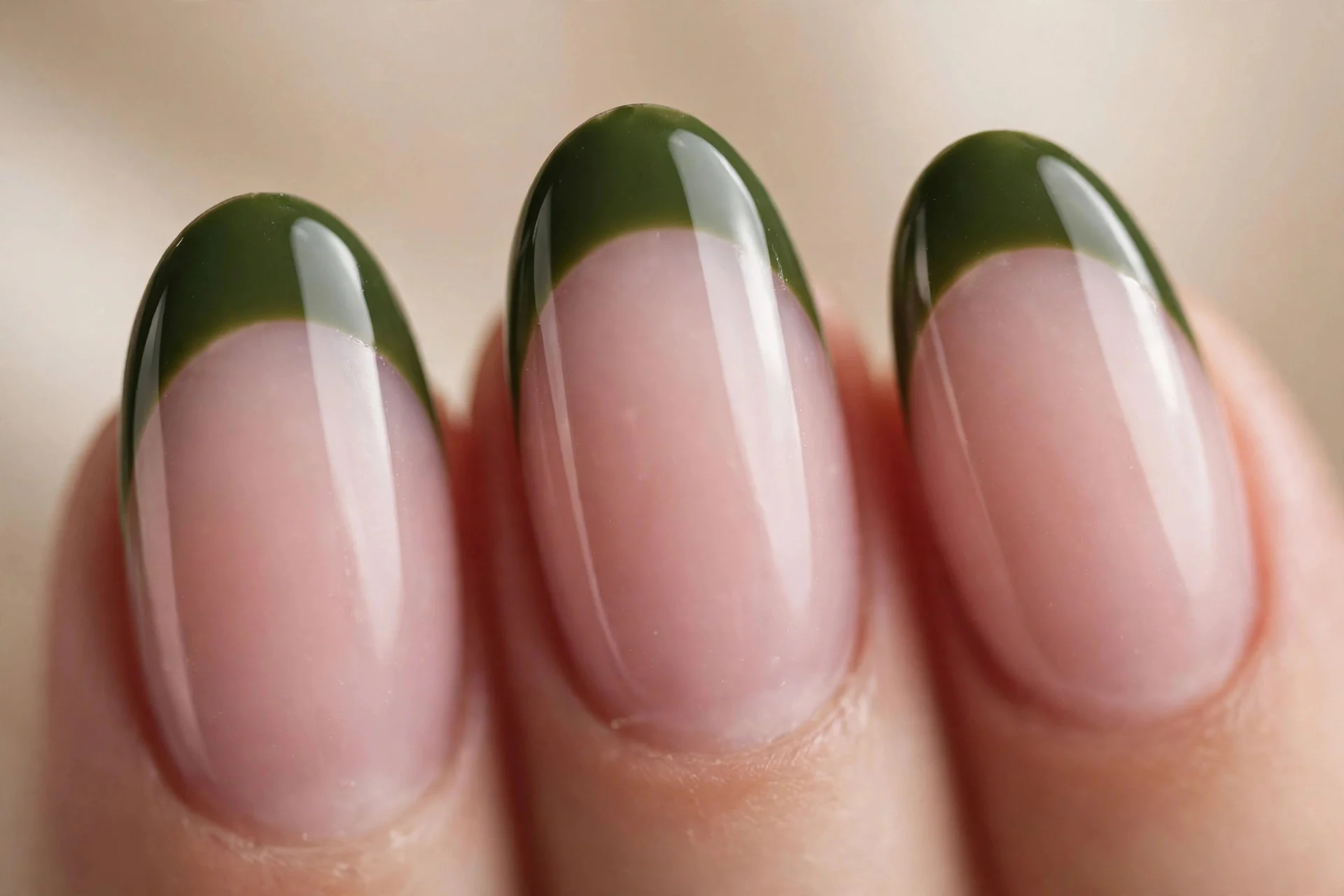 Oval French nails with deep matcha tips over sheer pink, glossy, beige background