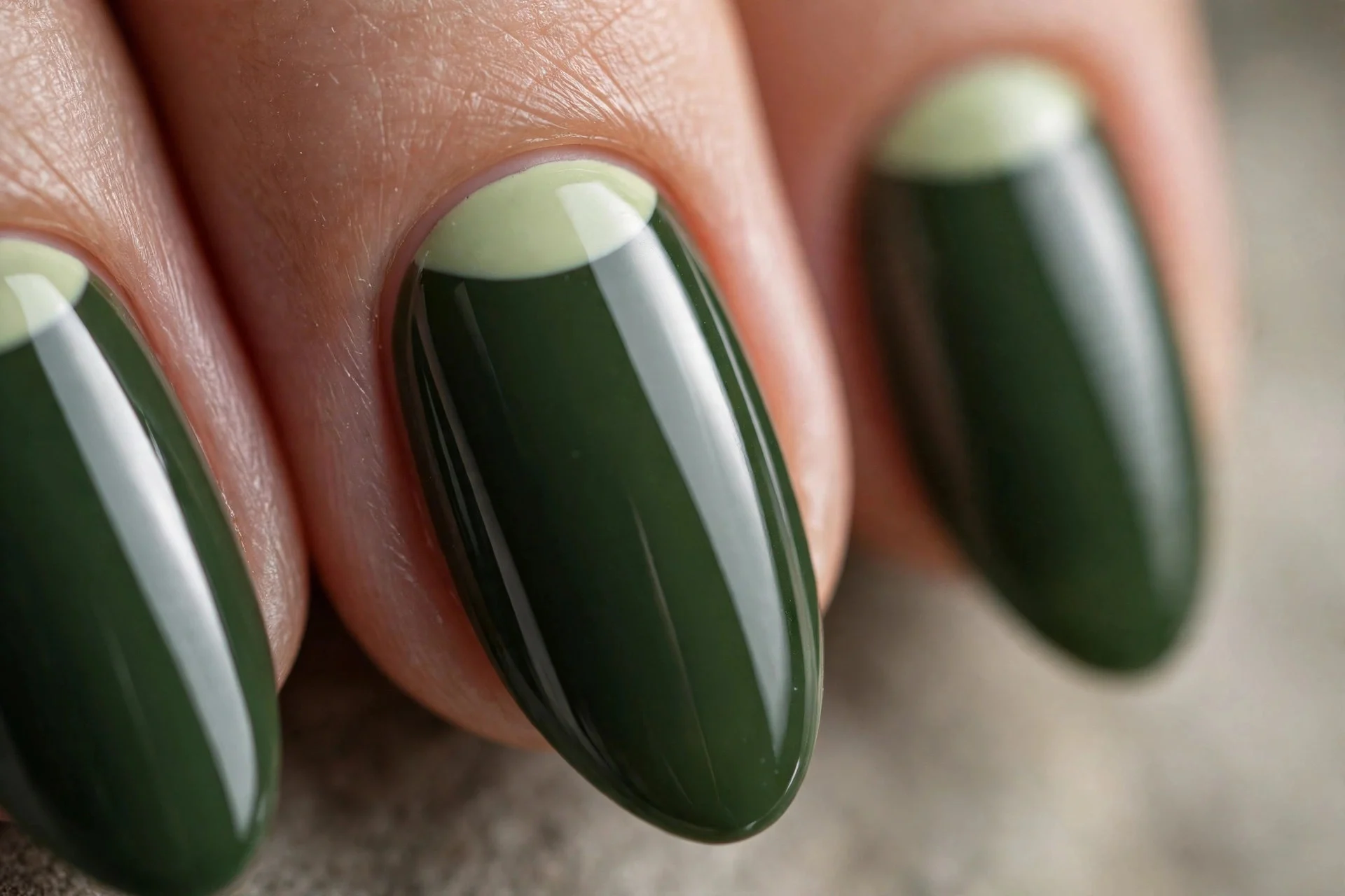 Almond nails in deep matcha with pale matcha half-moons at cuticles, glossy, neutral background