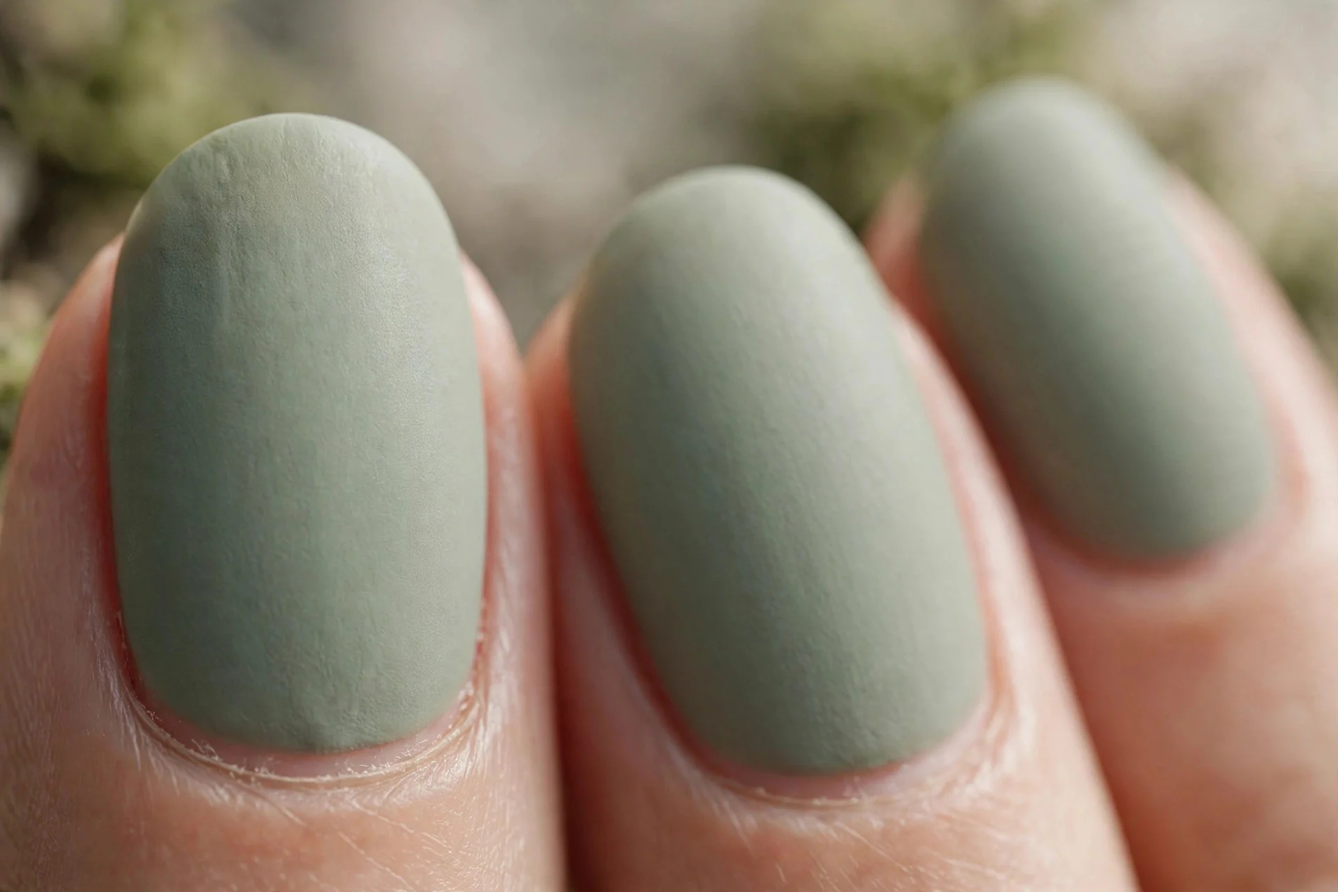 Muted sage green polish, oval nails