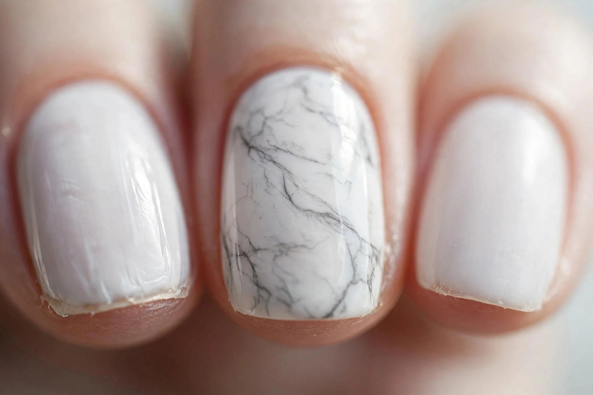milky white nails with fine grey marble veining on accent nails