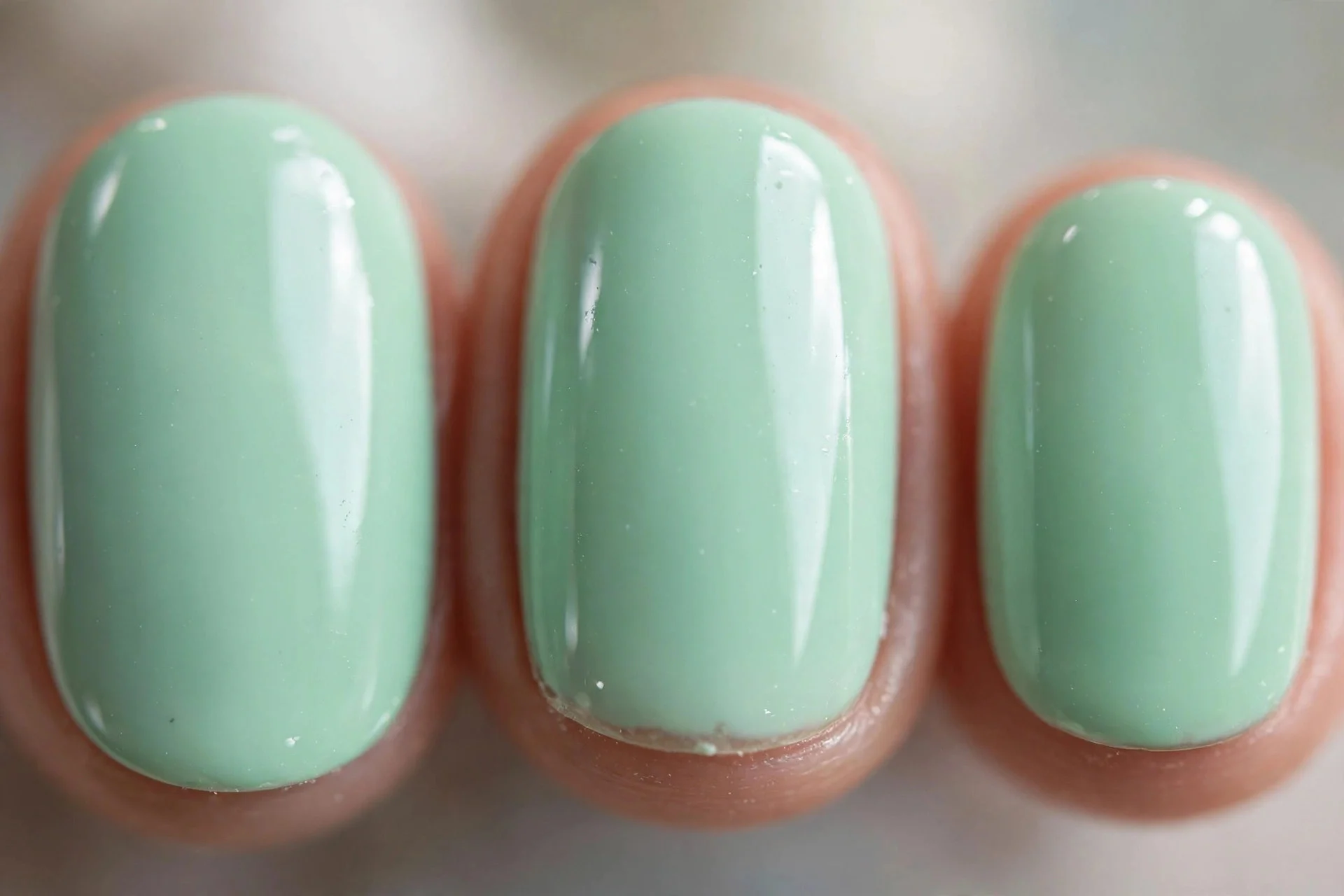 Mint green cream polish, short oval nails, glossy