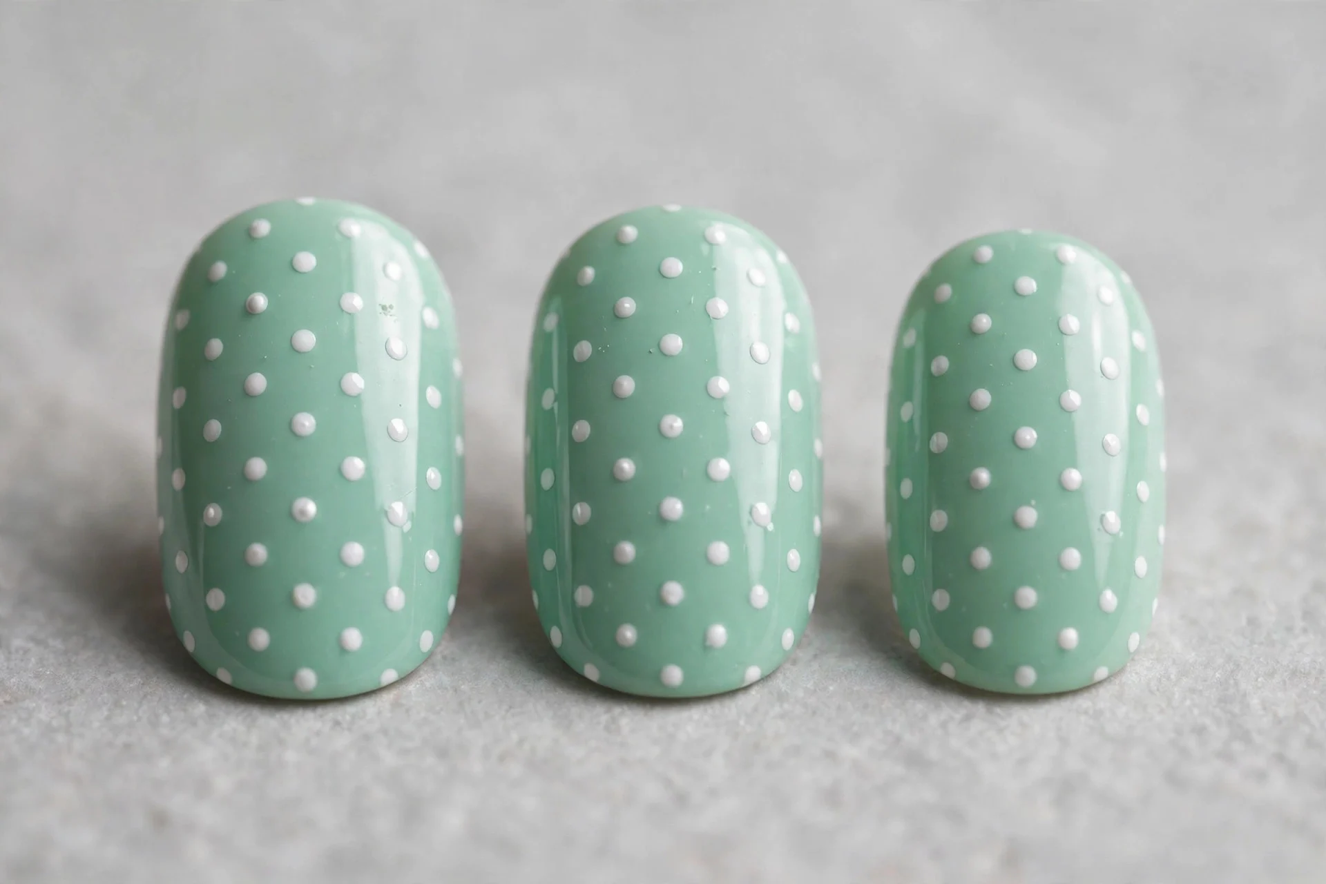 Mint nails with white polka dots, short oval nails