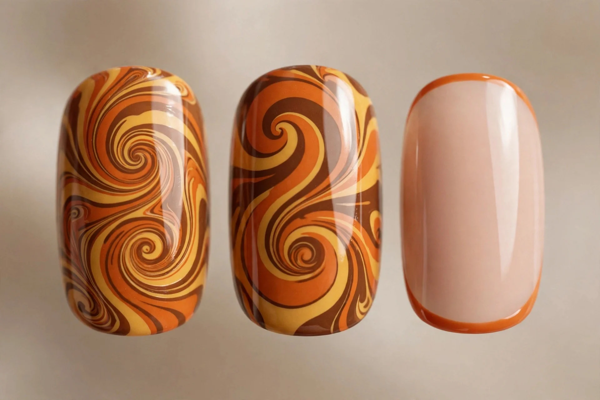 Extreme macro of three nails with retro swirls in orange, mustard, brown and micro French tips