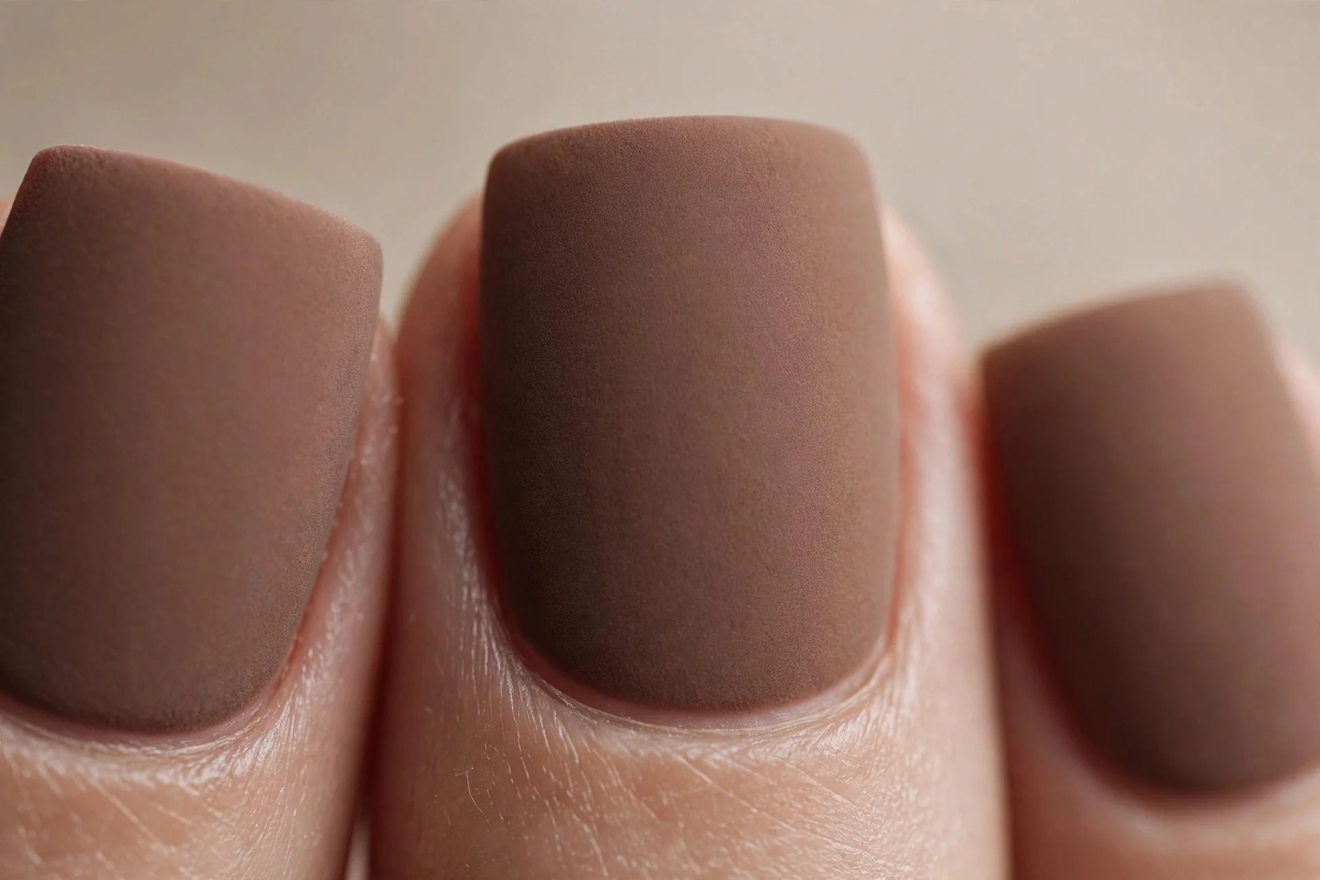 Square nails in solid matte mocha brown, velvety finish, neutral background