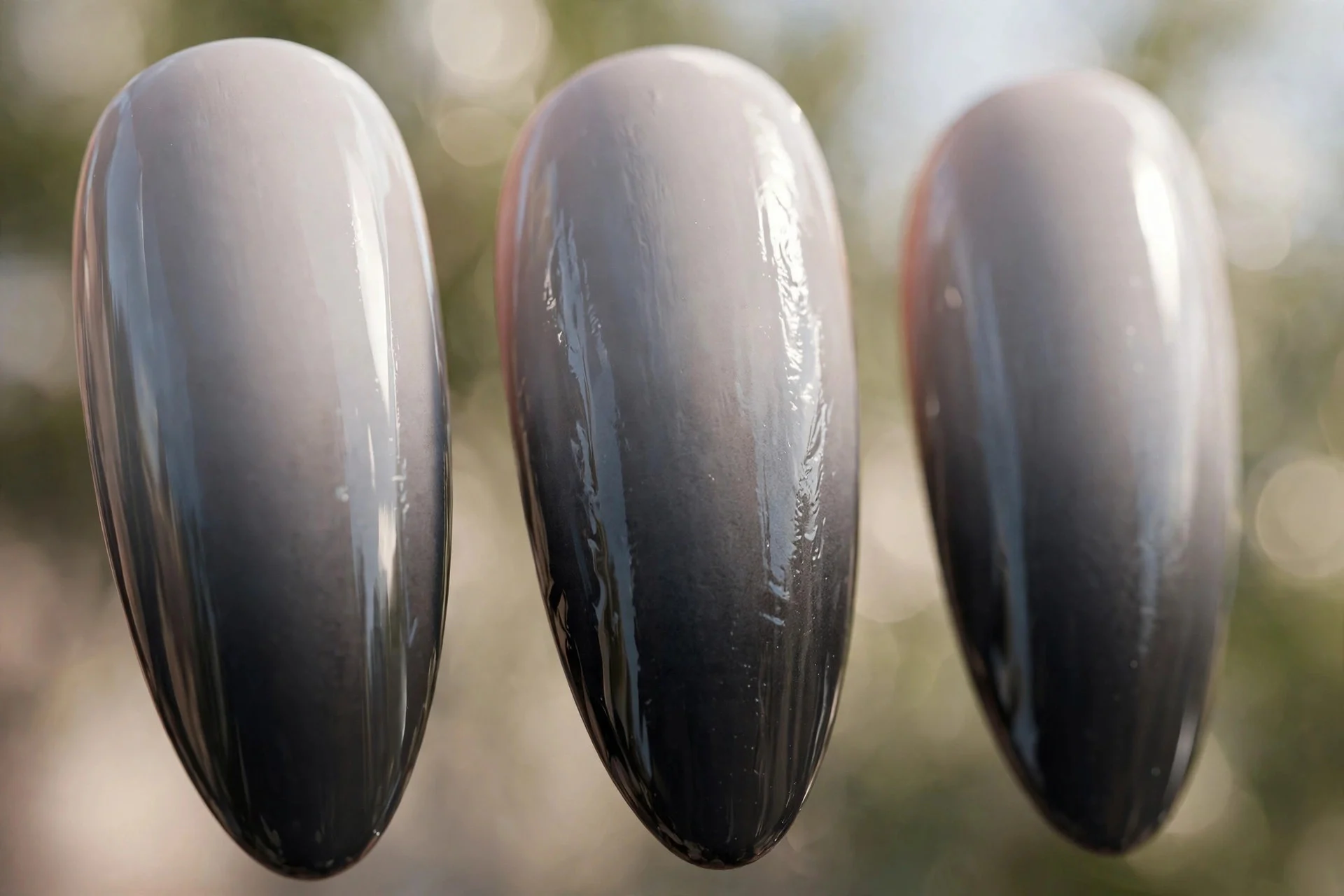 long almond nails with dove-grey-to-charcoal ombr&eacute; gradient, glossy finish