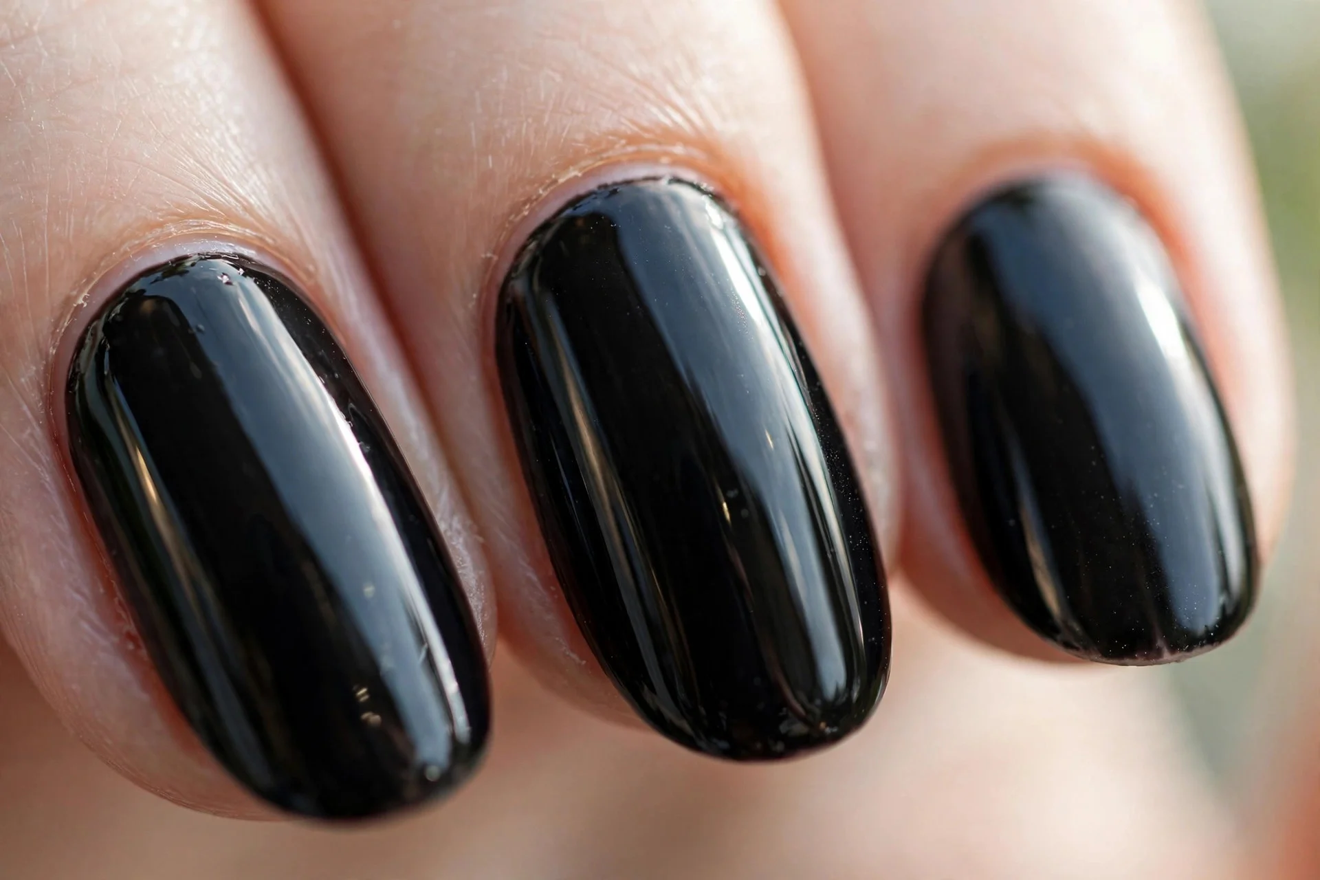 medium-length almond nails in high-gloss jet black