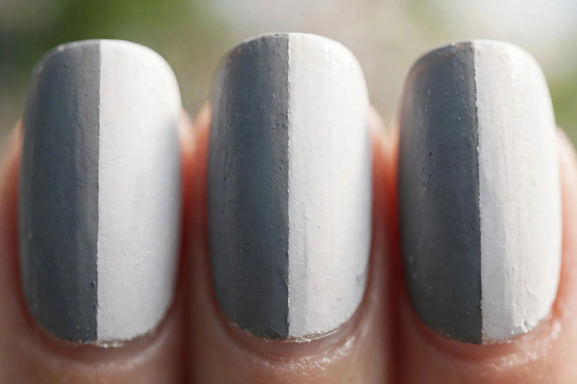 nails split vertically between slate grey and white with a crisp dividing line