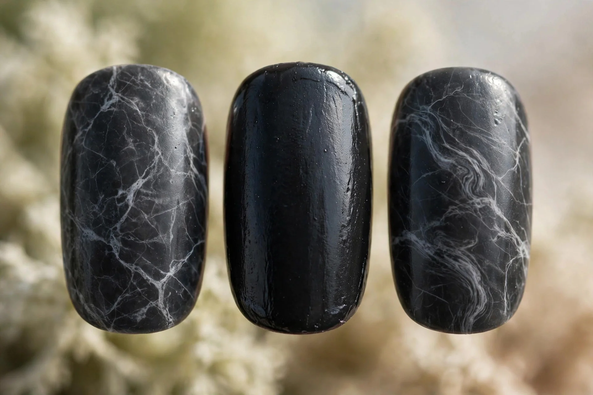 charcoal nails with fine white marble veining on two accent nails