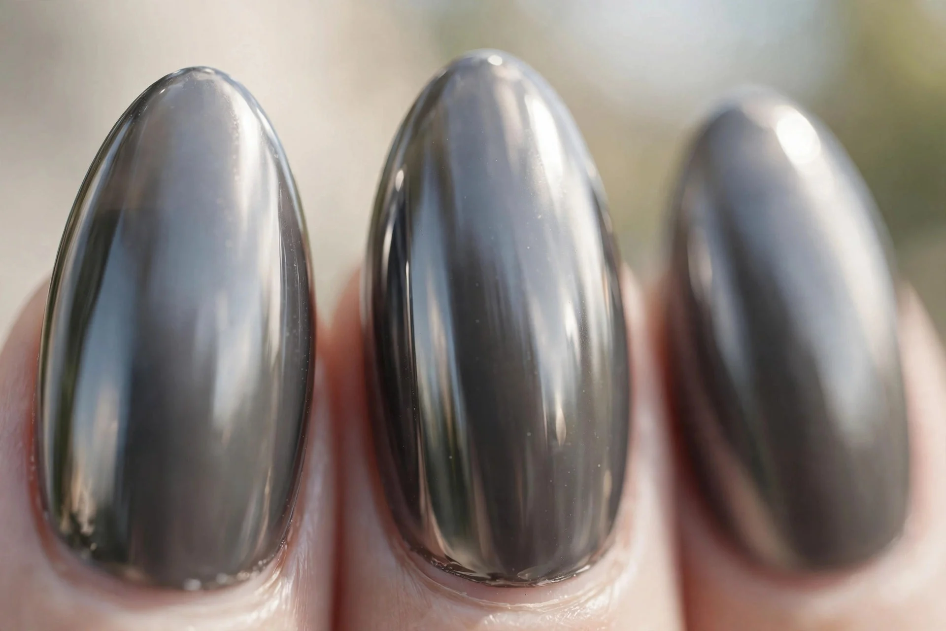 almond nails in smoky grey chrome with a mirror-like finish