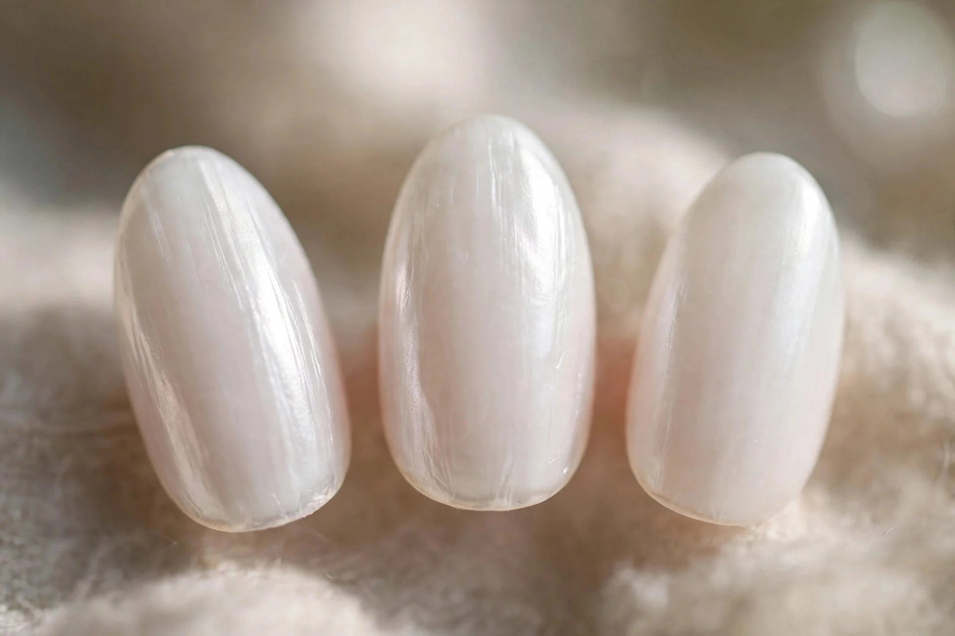 Milky white nails with pearl sheen, almond nails