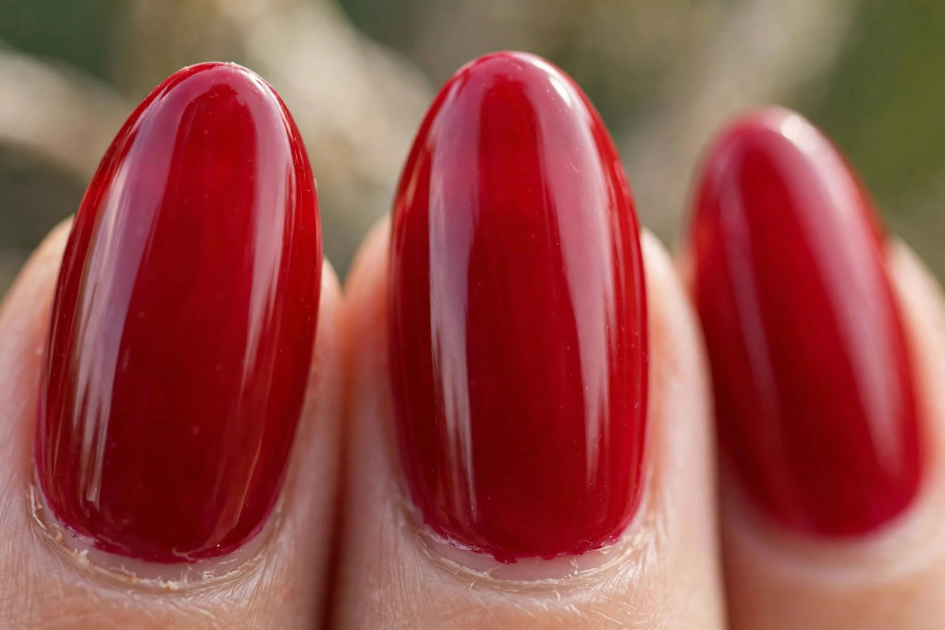 Classic ruby red glossy polish, almond nails