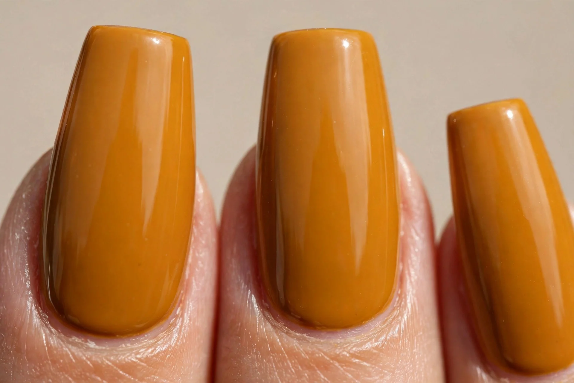 burnt mustard crème, medium-length coffin nails, high-gloss finish, no nail art