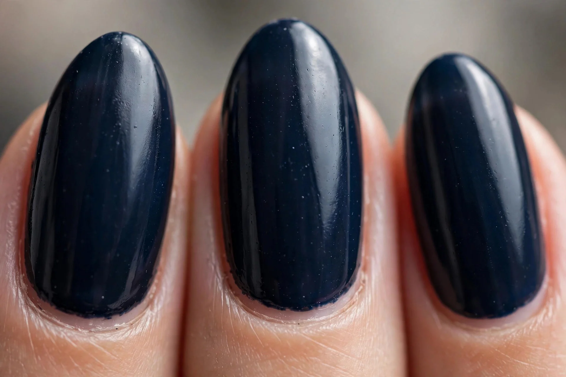 Dark ink navy near-black blue polish, medium almond nails