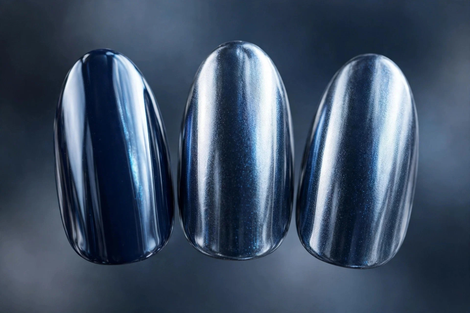 Navy polish with silver-blue chrome finish, almond nails, metallic