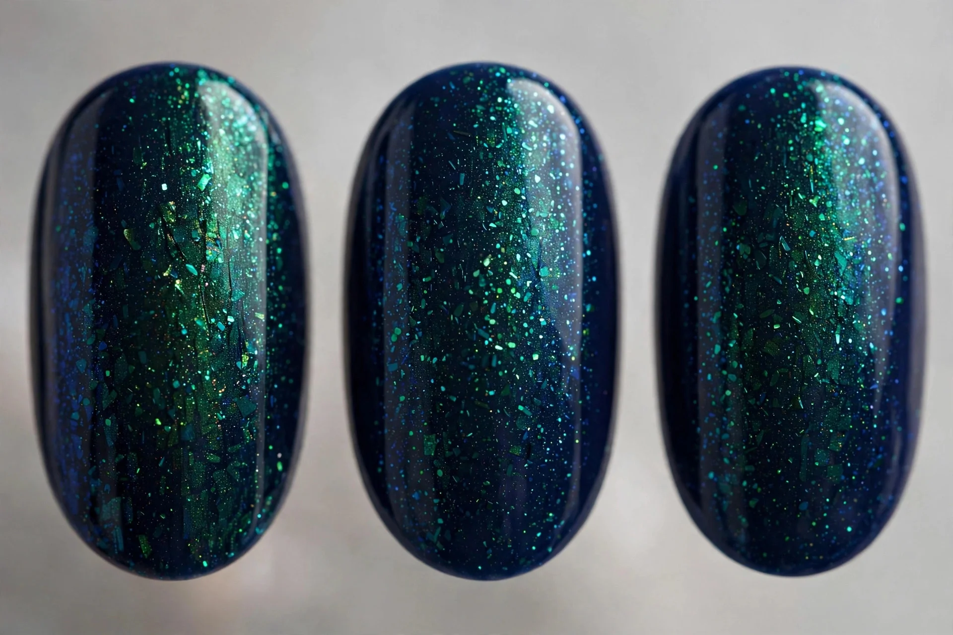 Navy polish with peacock green shimmer, oval nails