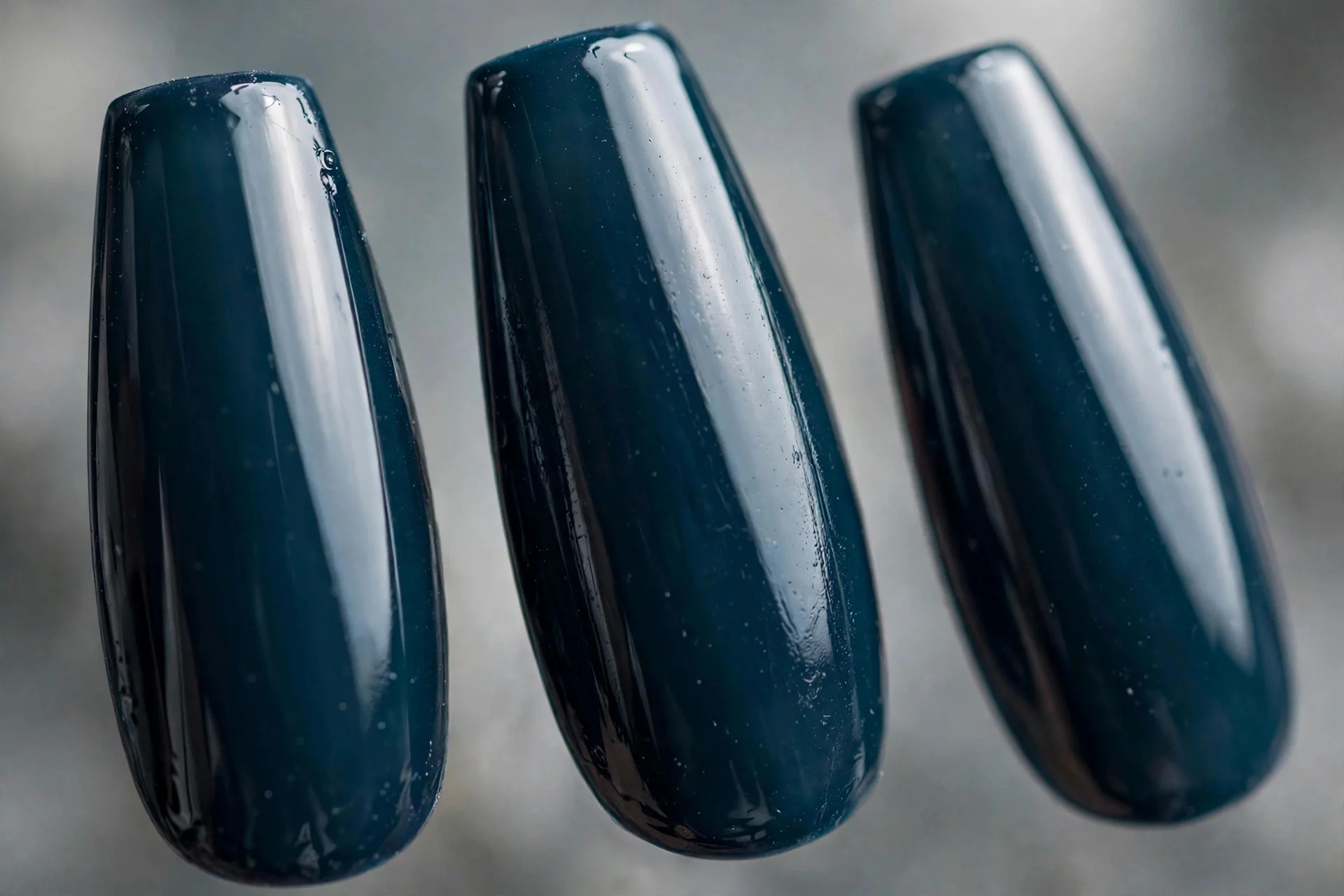 Dark teal-navy borderline polish, long coffin nails, glossy