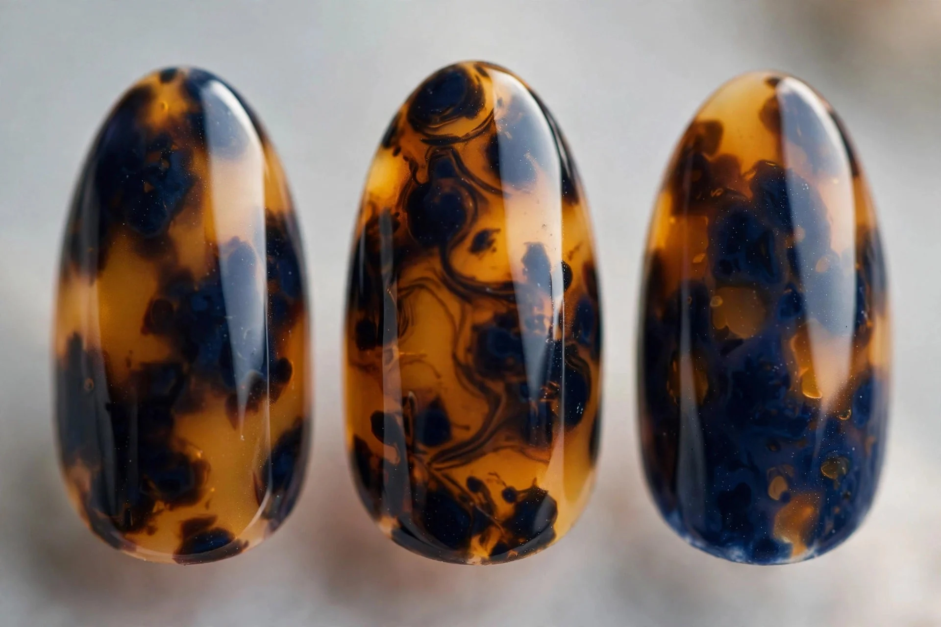 Navy and amber tortoiseshell nail art, almond nails