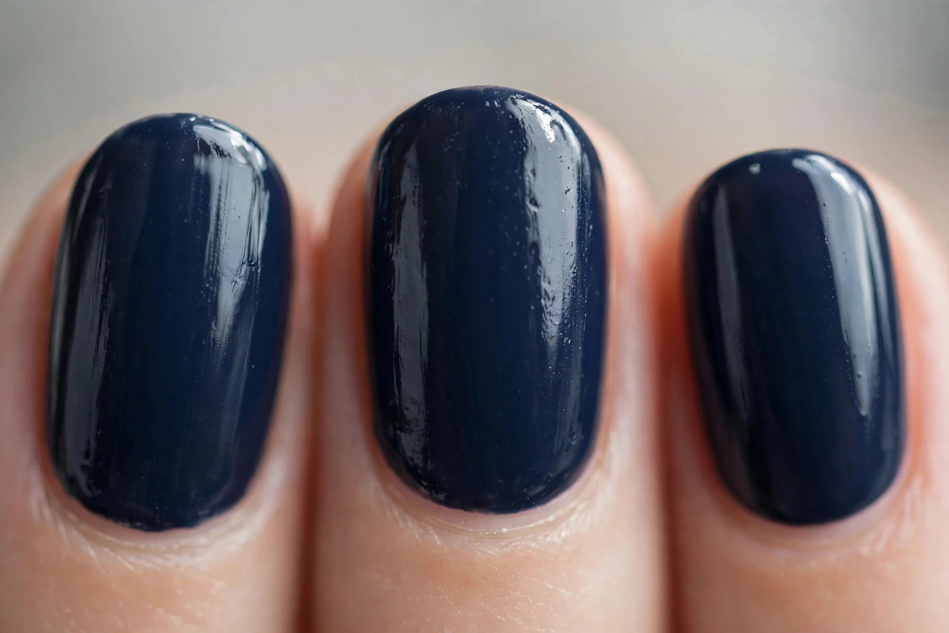 Classic navy cream polish, short oval nails, glossy