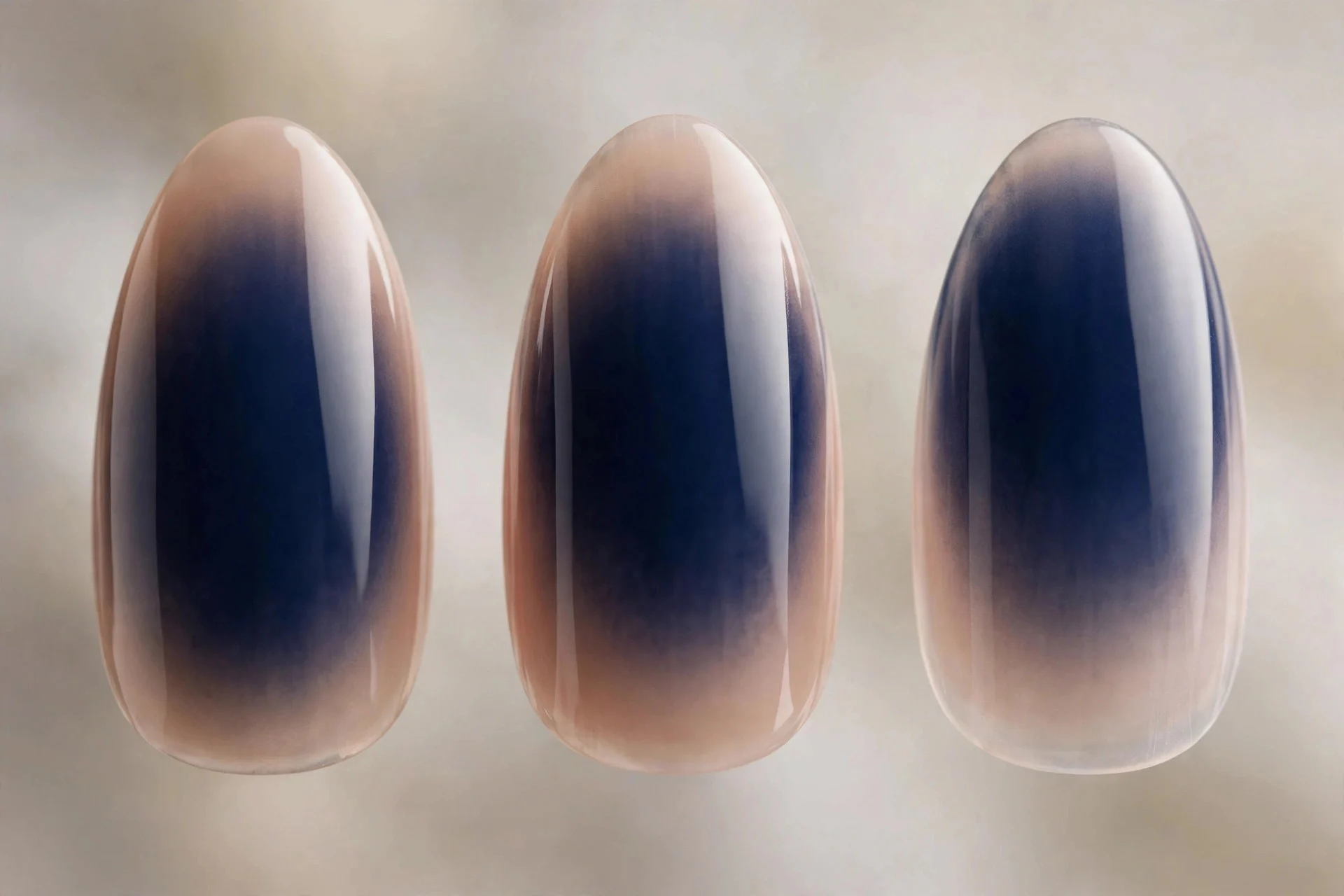 Navy aura fading to sheer nude edges, almond nails