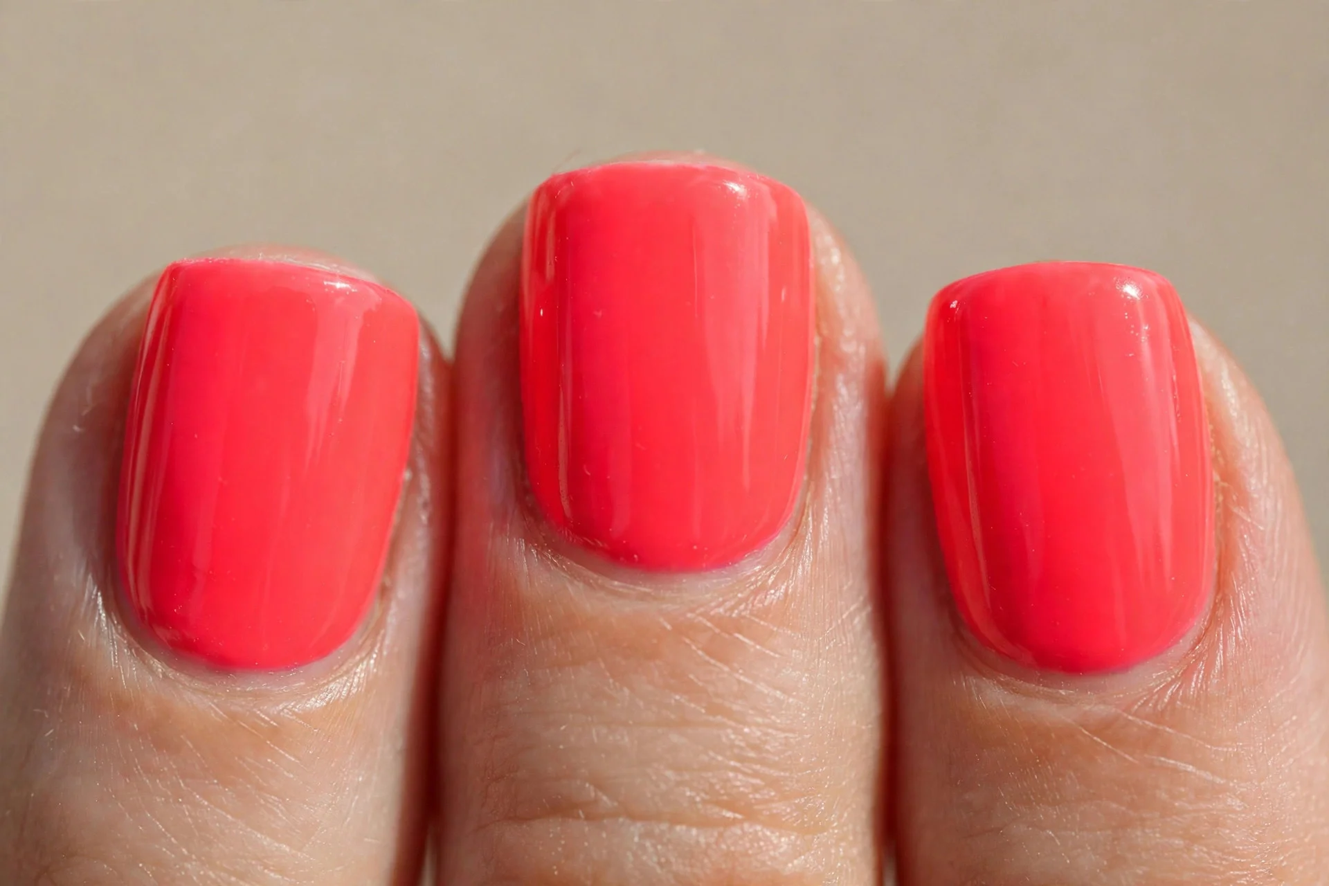 neon coral polish, short square nails, glossy