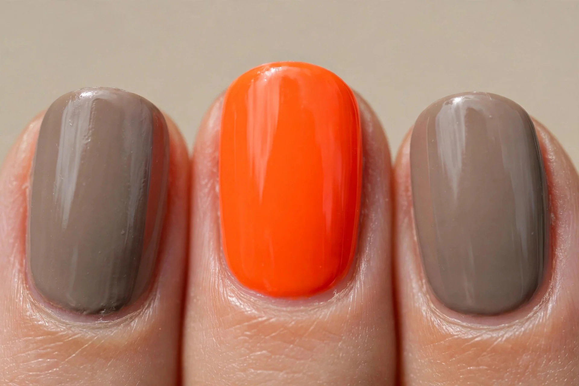 neon orange accent nail, taupe nails, short oval