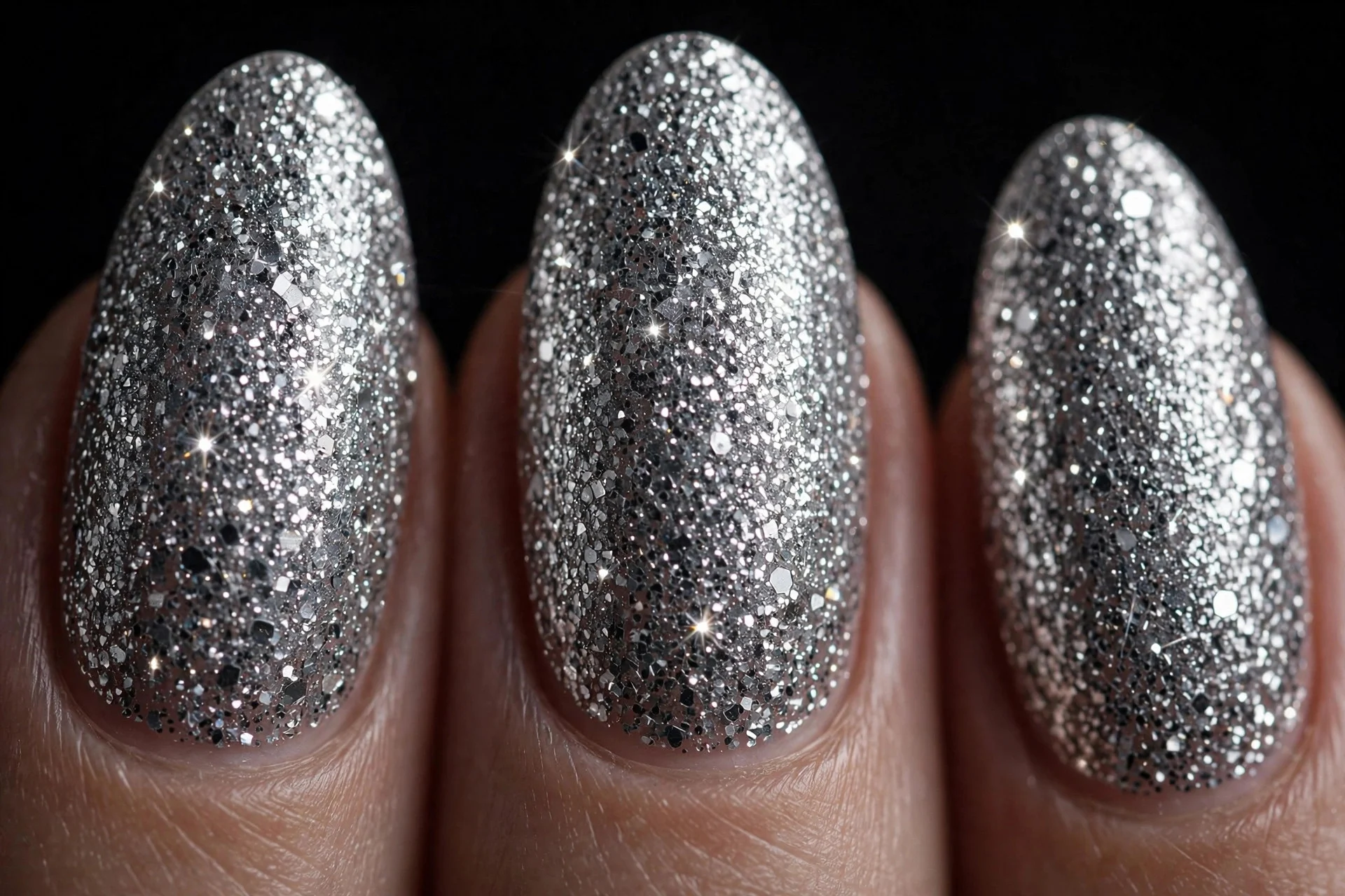 Almond nails in full silver disco glitter, dark background