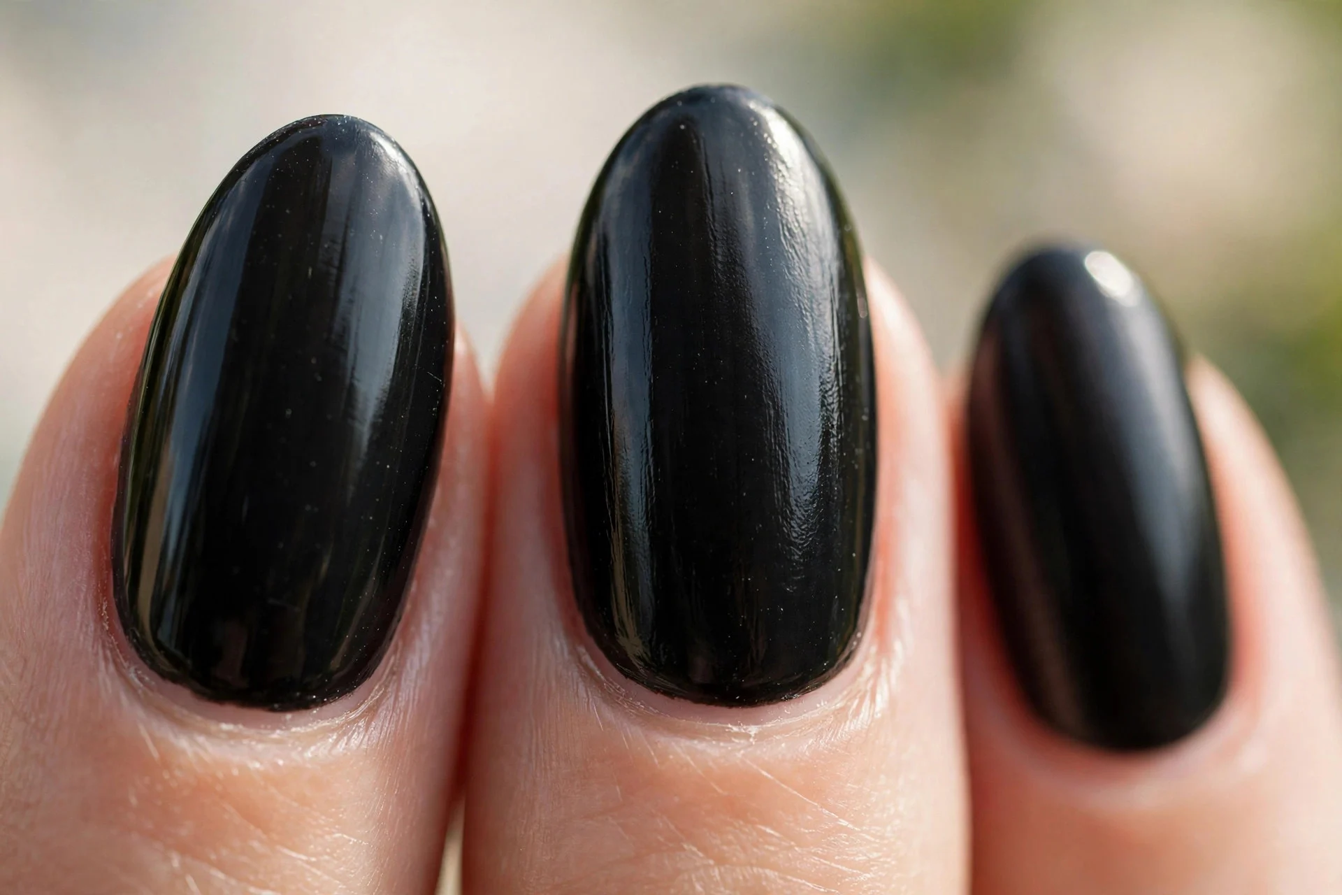glossy jet black nails in medium almond shape
